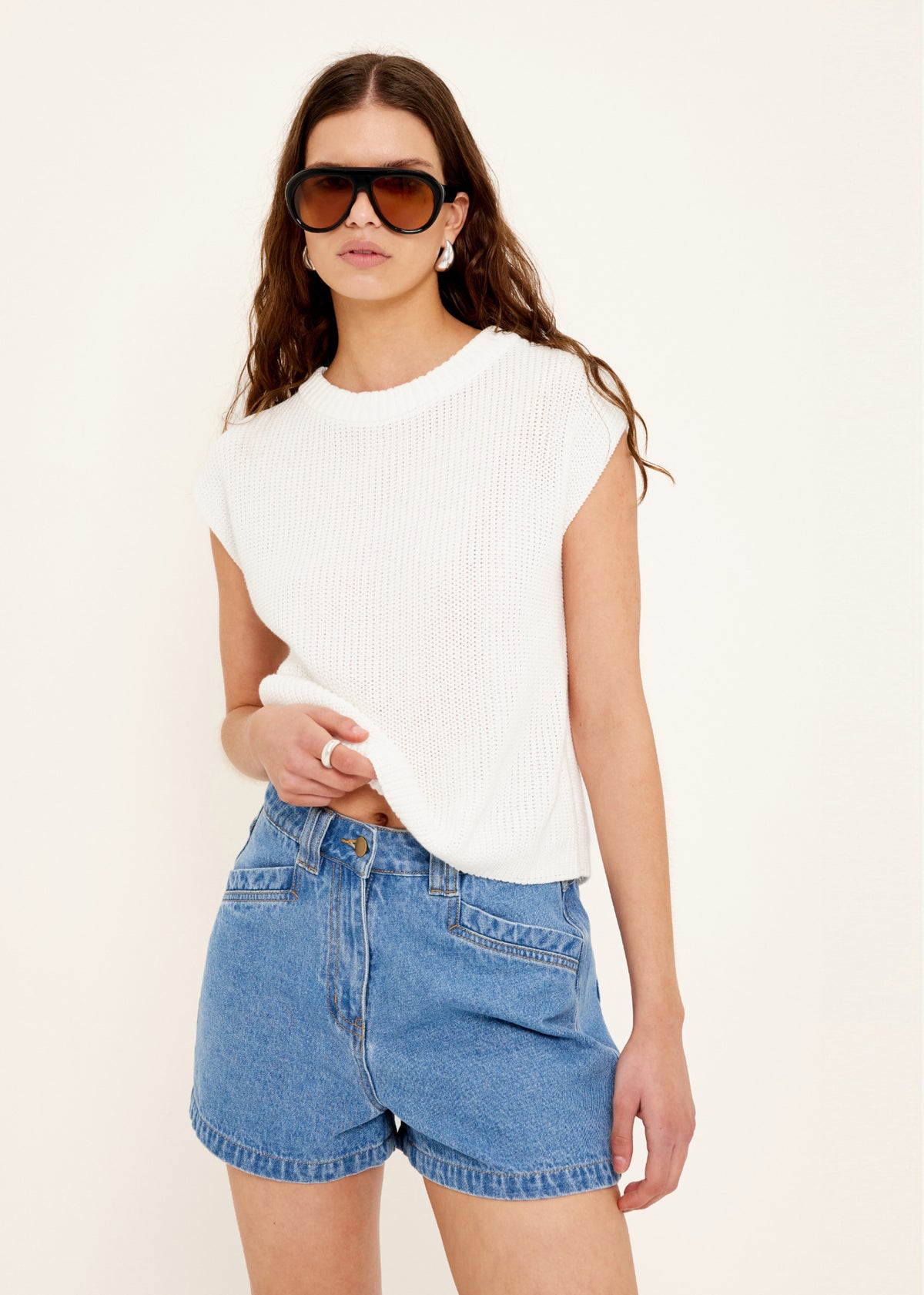 Close-up of the Mid-Blue Denim Shorts, showing a zip and button closure.