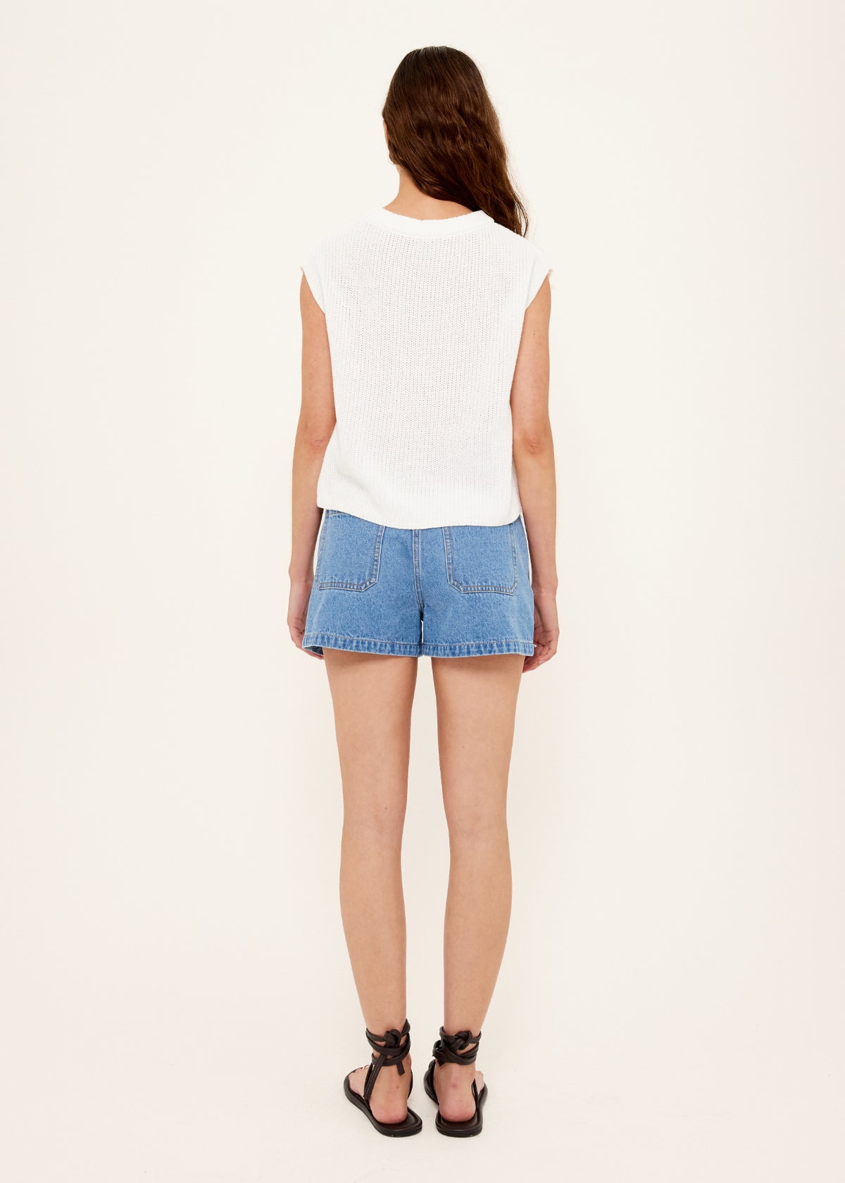 Back view of the Mid-Blue Denim Shorts with a zip and button closure.