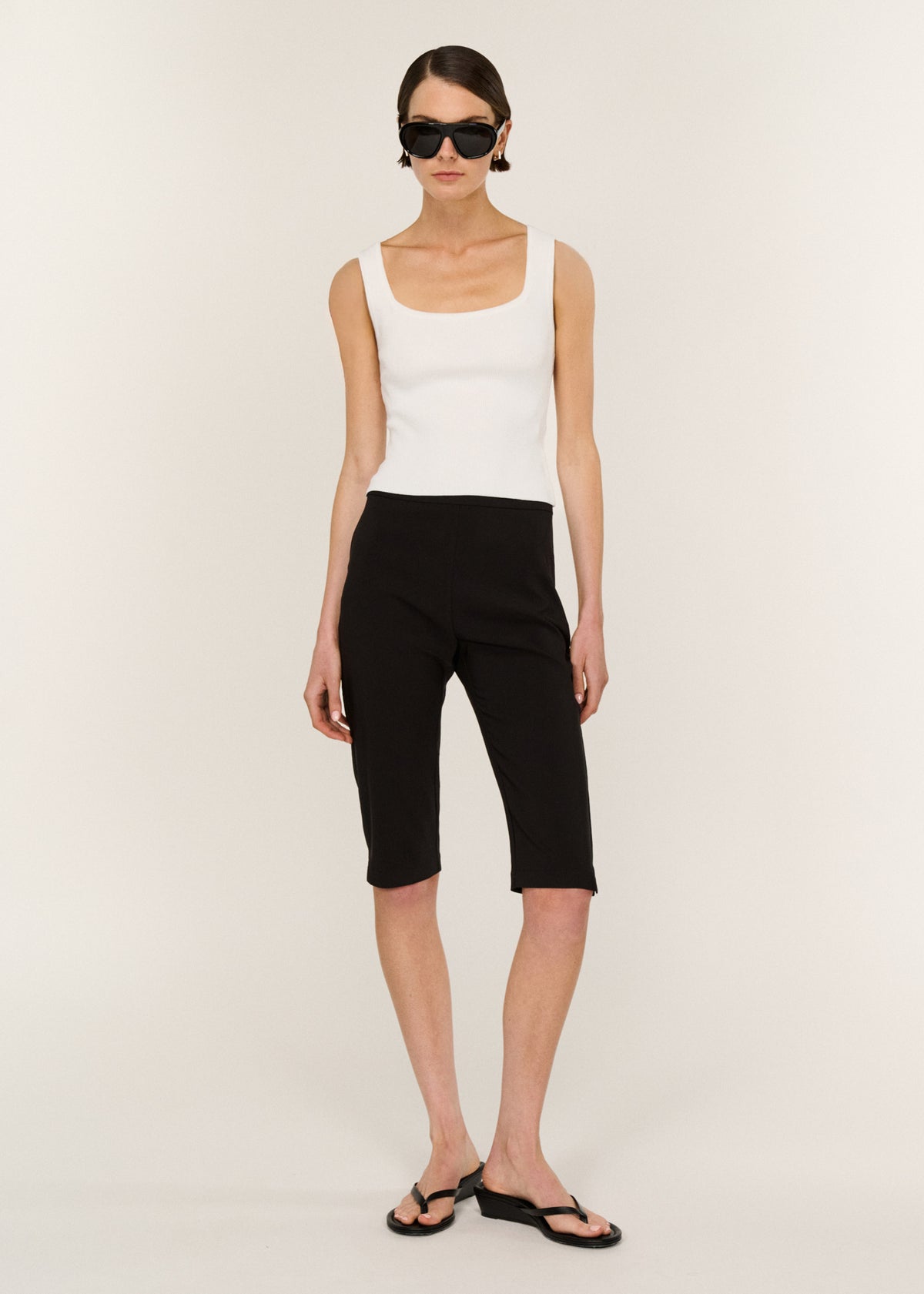 Model wearing Mid Rise Capri Pants in Black, showing a classic black colourway and a high-rise waist.