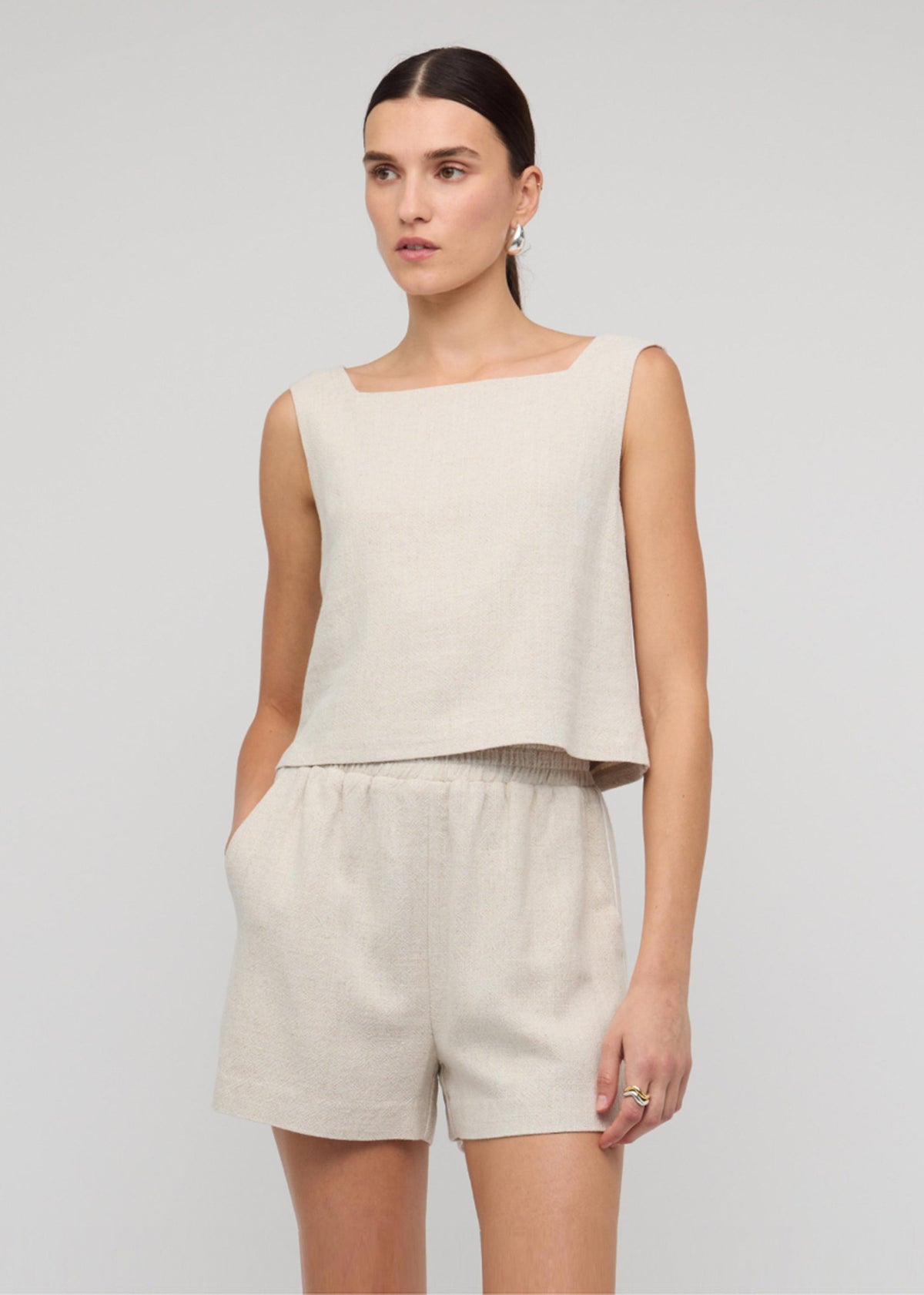 Model wearing Natural Marle Relaxed Linen Shorts, showing a soft, breathable fabrication and a relaxed fit with elastic waistband.