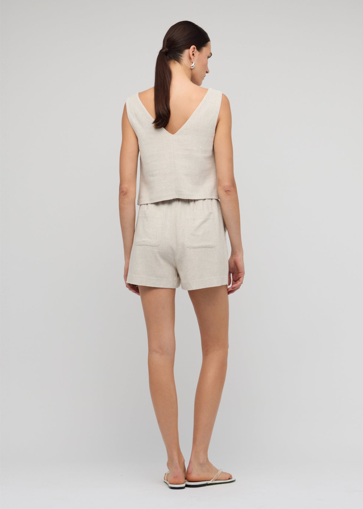 Back view of the Natural Marle Relaxed Linen Shorts with side and back pockets.