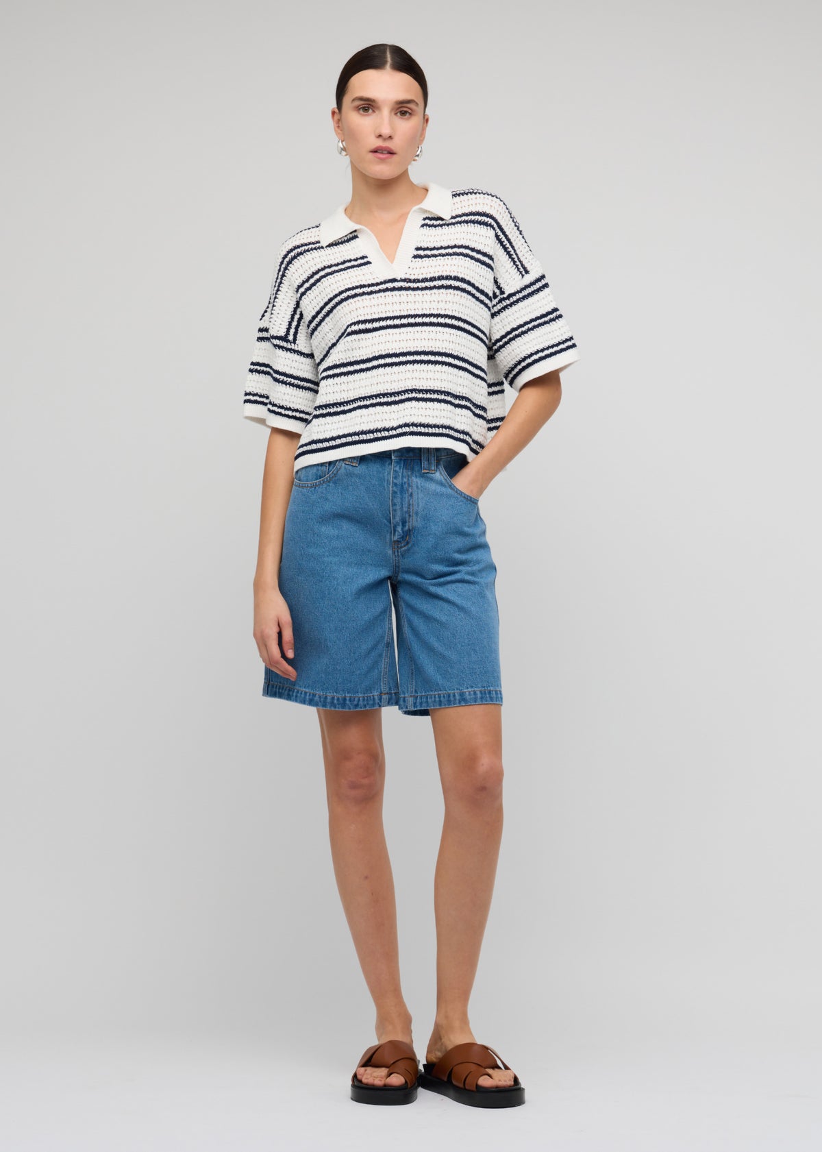 Model wearing Navy and White Knit Polo Top with a relaxed, boxy fit and a short sleeves with drop shoulder.