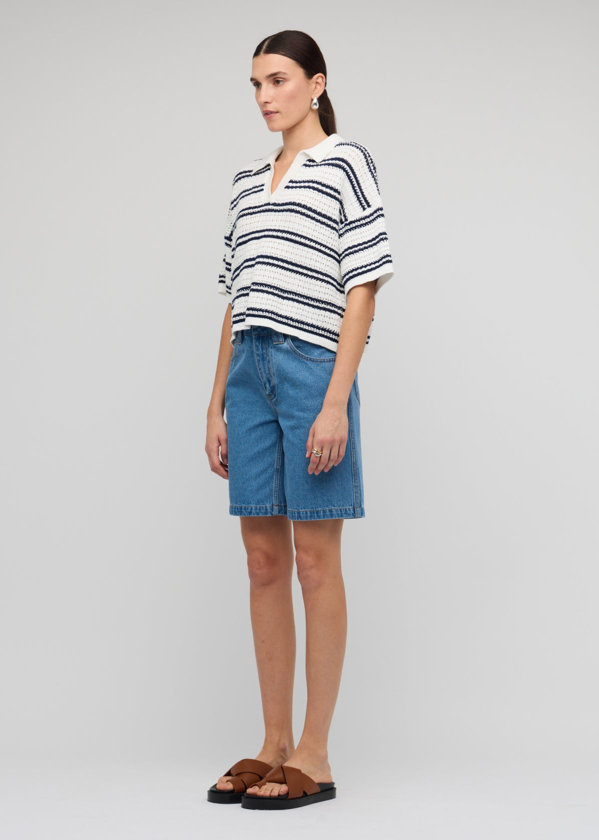 Side view of the Navy and White Knit Polo Top, showing an open V-neckline and a lightweight summer knit.