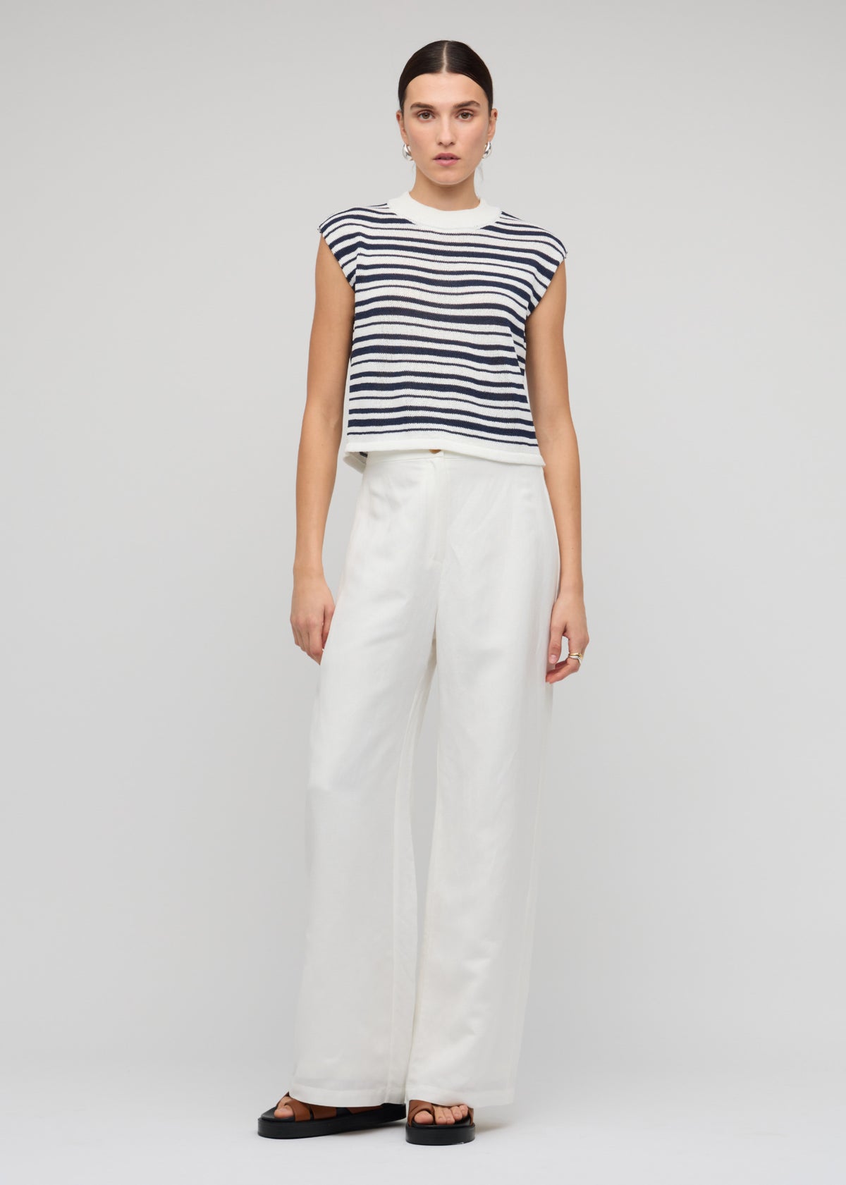 Model wearing Navy and White Stripe Knit Tank Top with a sleeveless tank silhouette.