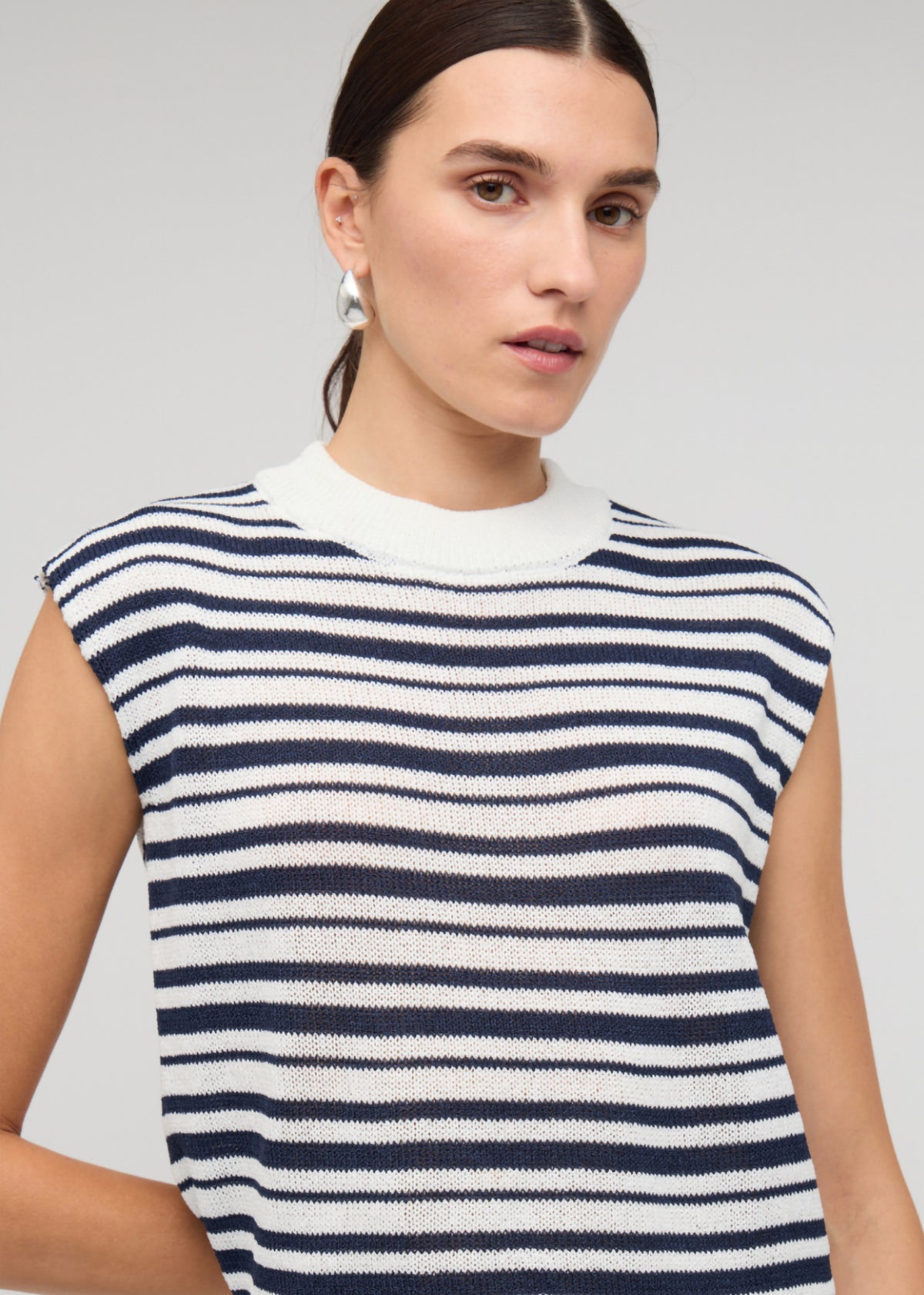 Close-up of the Navy and White Stripe Knit Tank Top, showing a sleeveless tank silhouette and a crew neckline with ribbed finish.