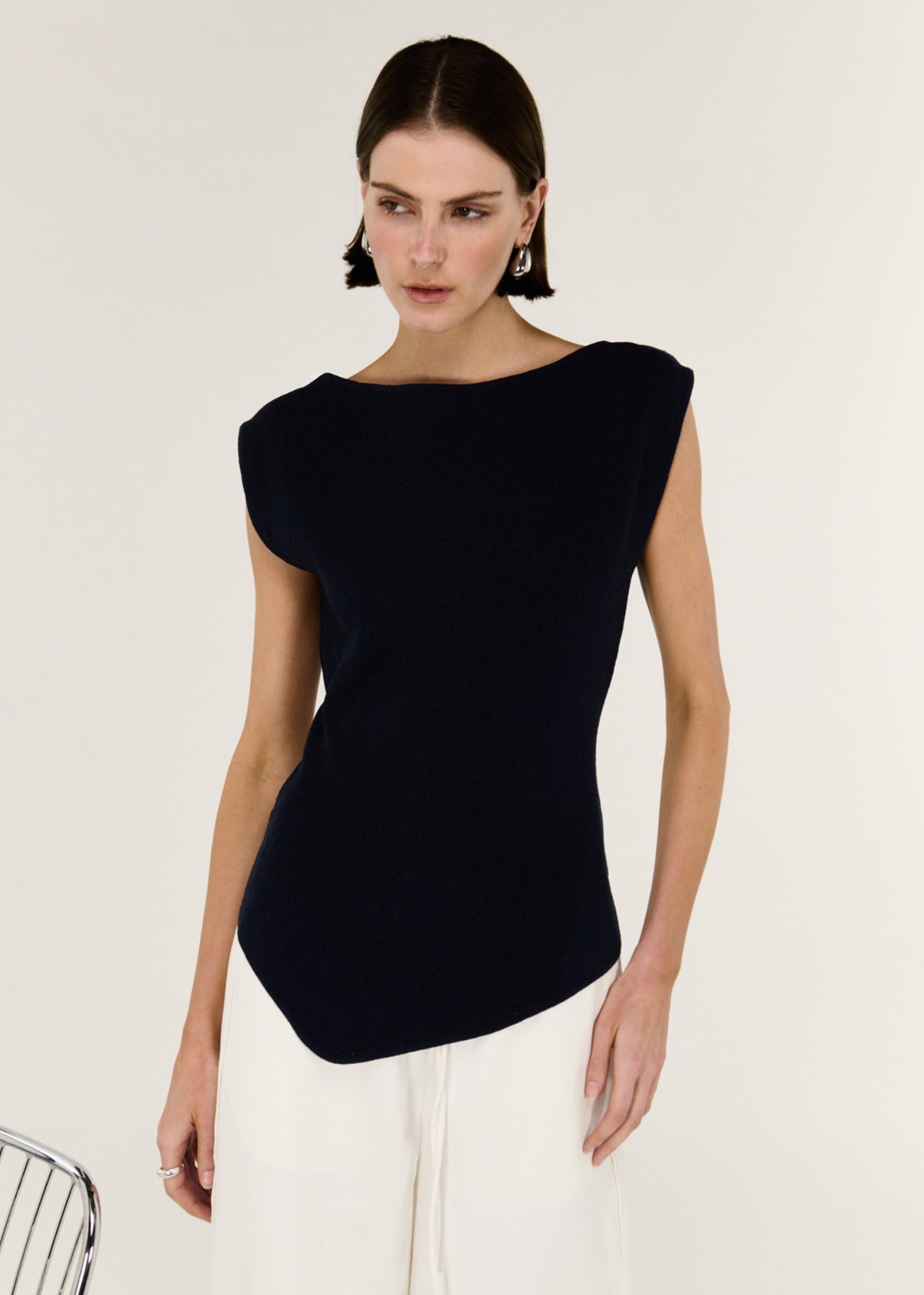 Close-up of the Navy Boat Neck Knit Top, showing a sleeveless cut and a clean boat-style neckline.