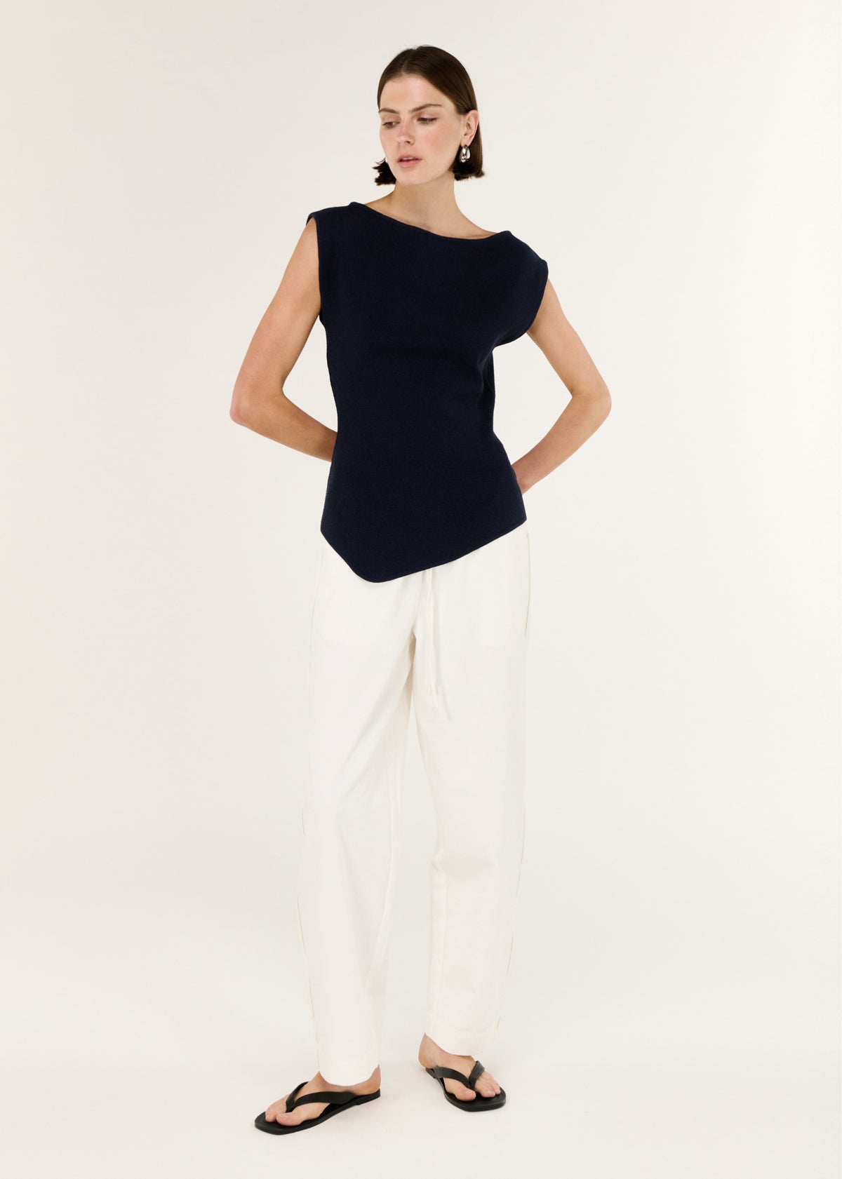 Model wearing Navy Boat Neck Knit Top with a sculpted, body-skimming fit and a clean boat-style neckline.