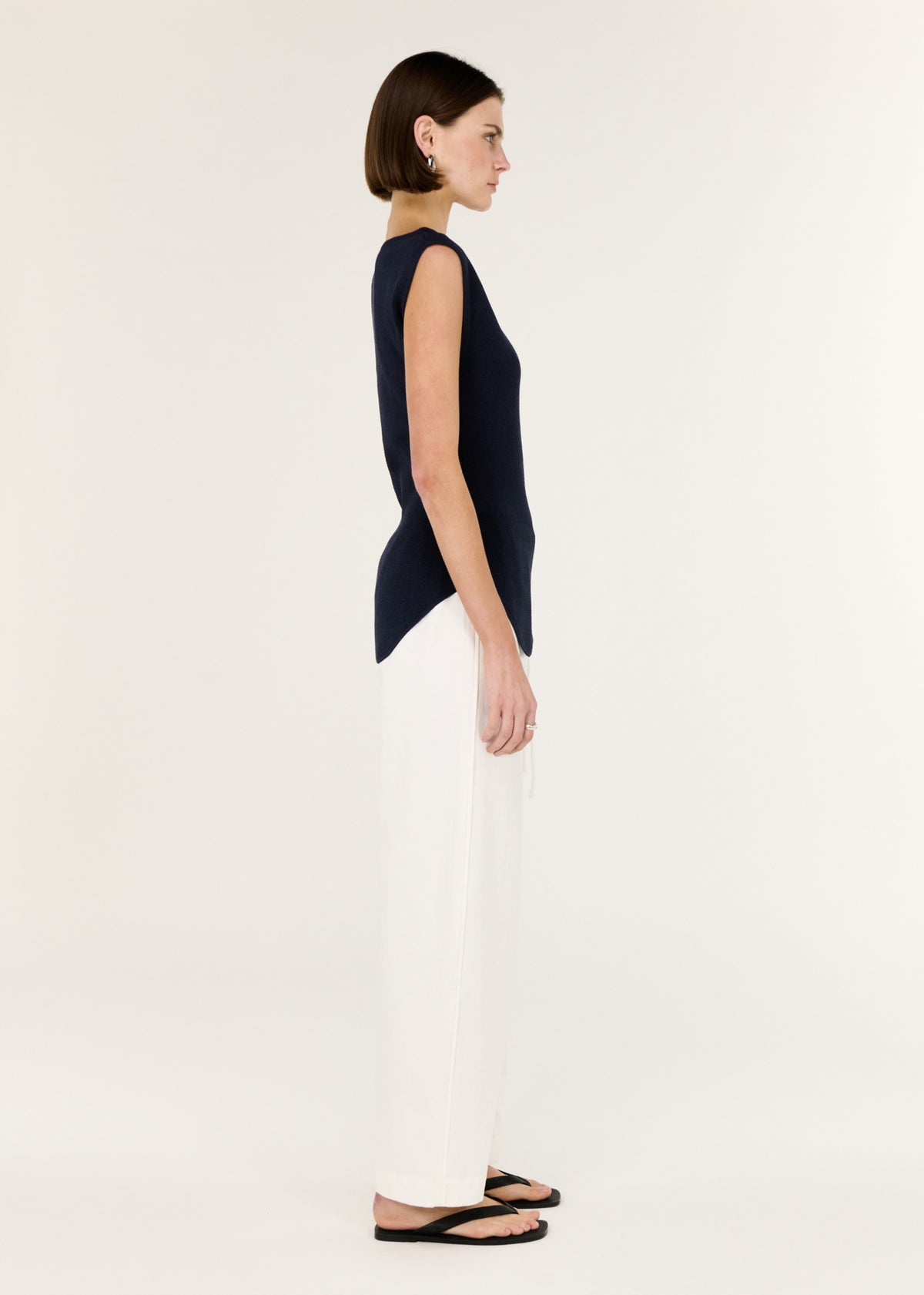 Side view of the Navy Boat Neck Knit Top, showing a clean boat-style neckline and a soft stretch knit fabrication.