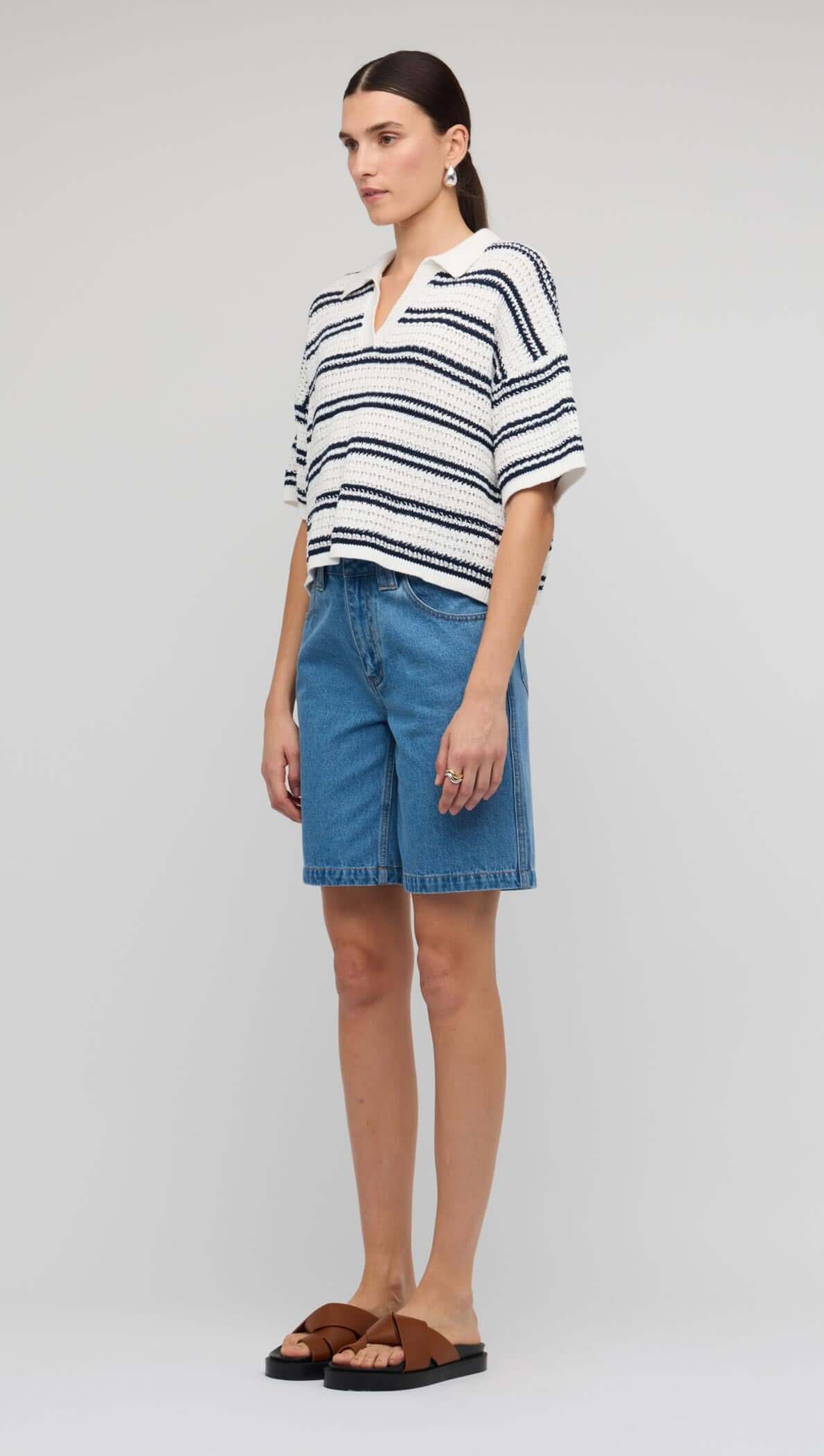 Navy & White Knit Polo Top model wearing casual outfit with denim shorts and sandals.