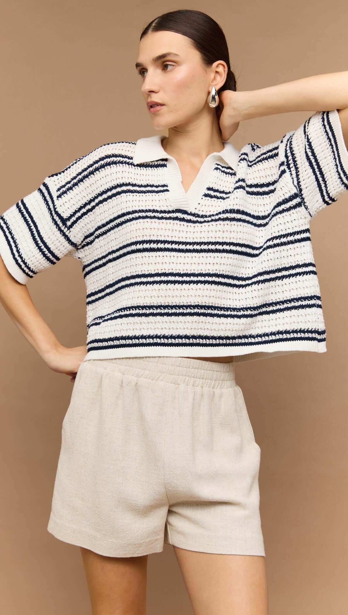 Navy & White Knit Polo Top worn with beige shorts, showcasing a relaxed summer style and modern V-neck design.