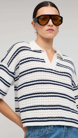 Navy & White Knit Polo Top shown on model, featuring a deep V-neck and short sleeves with navy stripes.
