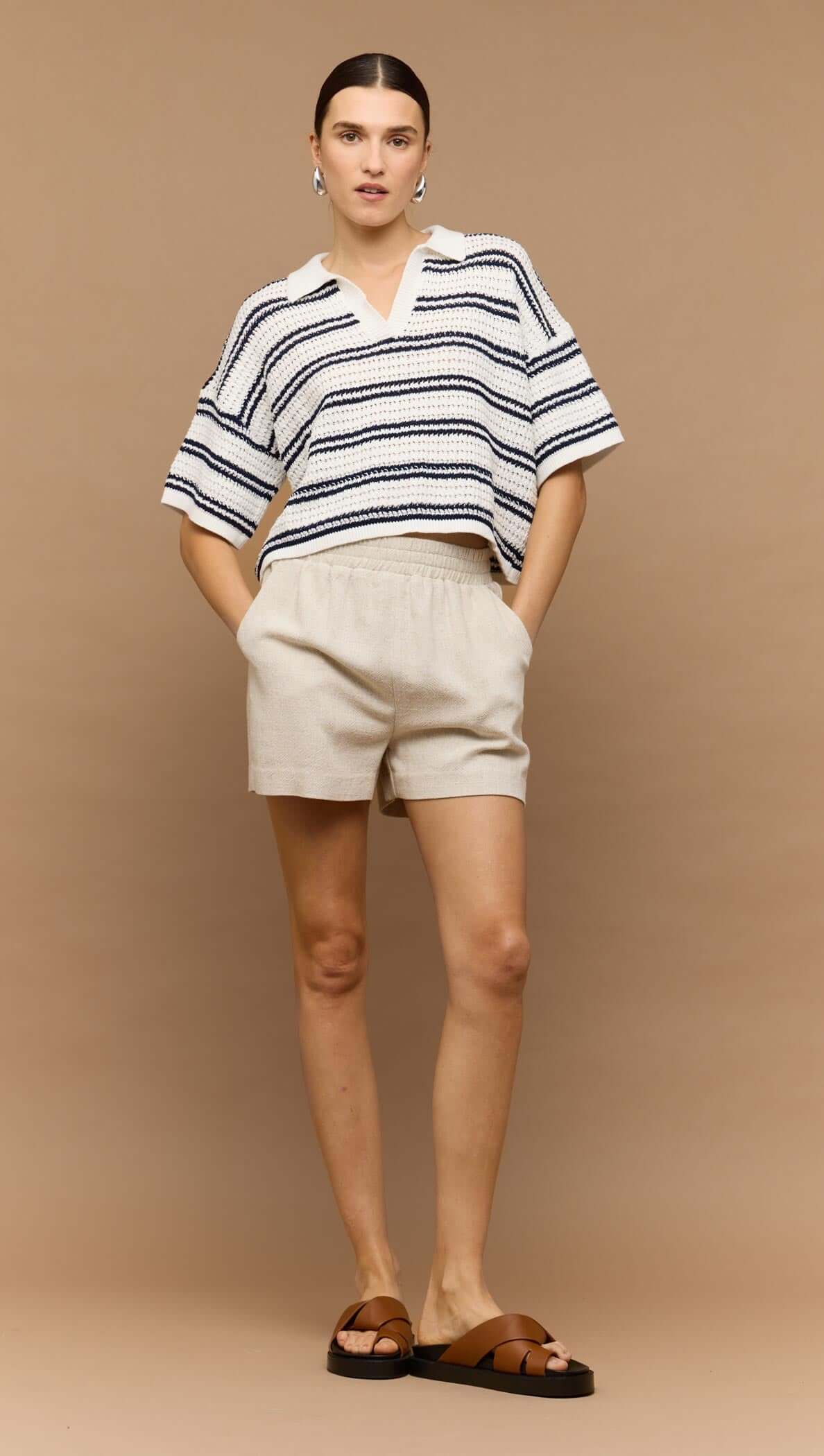 Navy & White Knit Polo Top worn with beige shorts, showcasing a relaxed summer style and modern V-neck design.