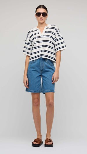 Model wearing Navy & White Knit Polo Top styled with denim shorts and sunglasses.