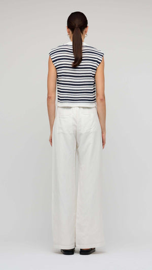 Back view of woman wearing a Navy & White Stripe Knit Tank Top with wide-leg pants.