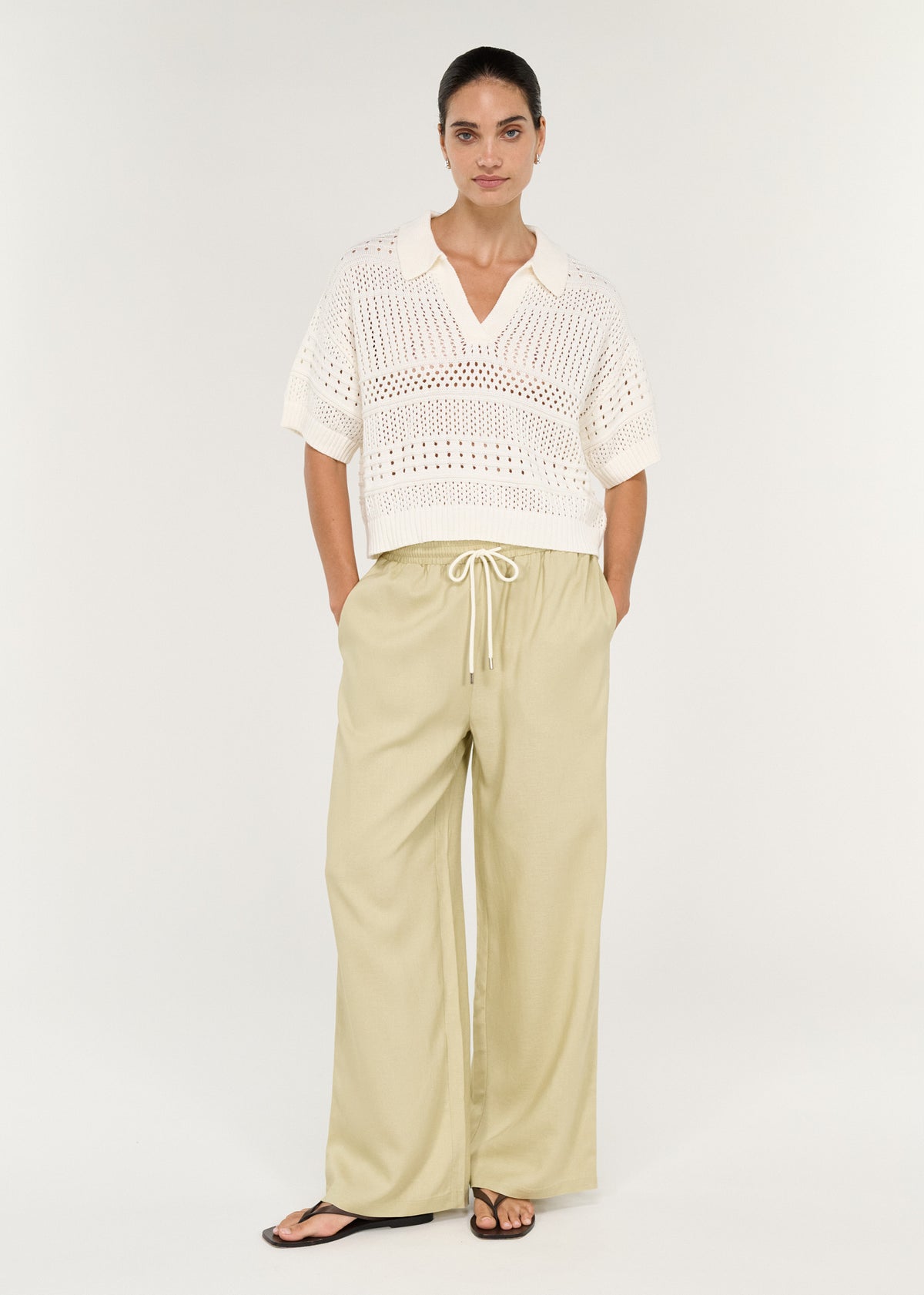 Relaxed Crochet Polo Shirt in Cream styled with casual beige pants.