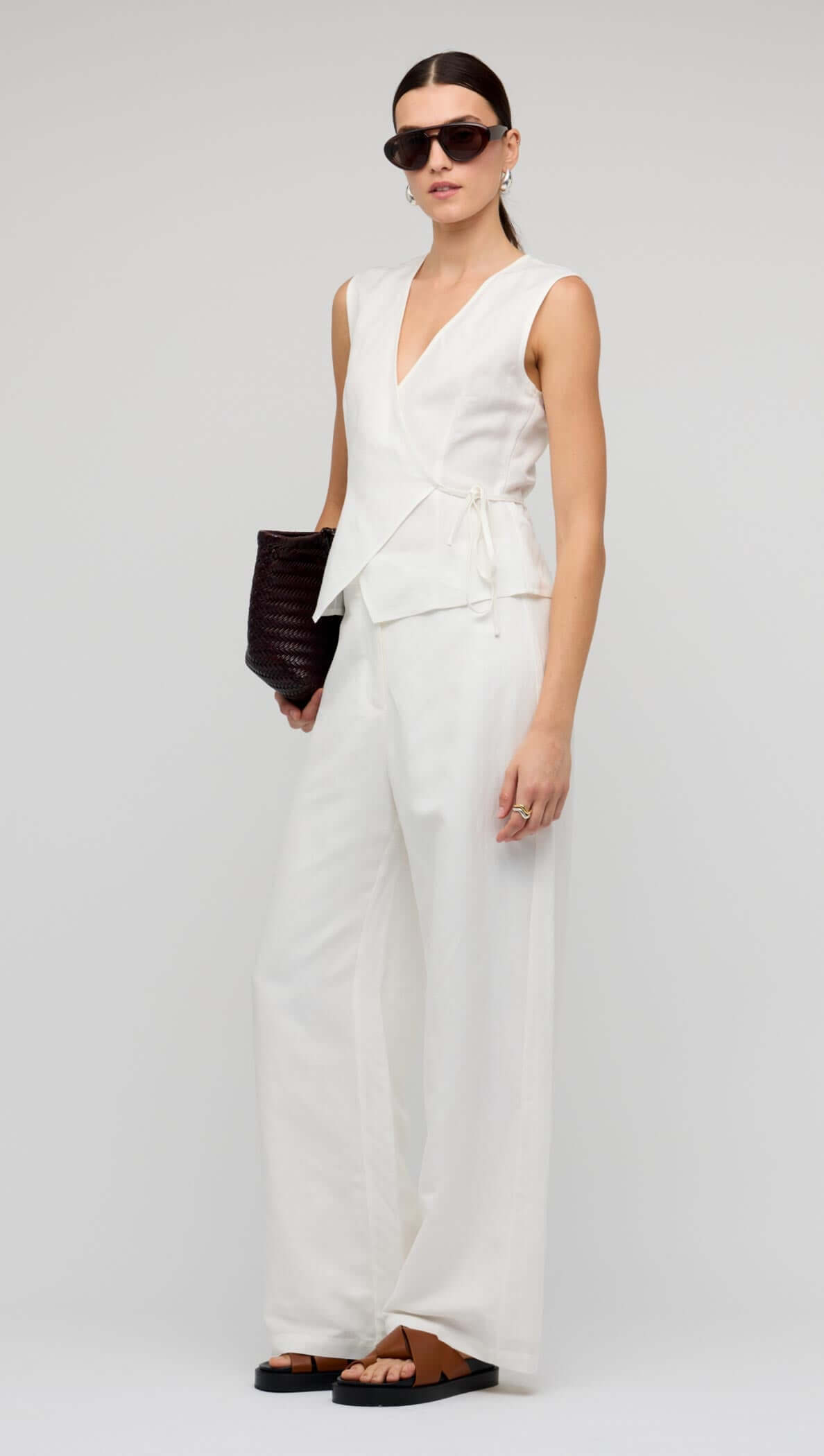 Model wearing White Linen Wide Leg Pants with a matching wrap top and sunglasses.