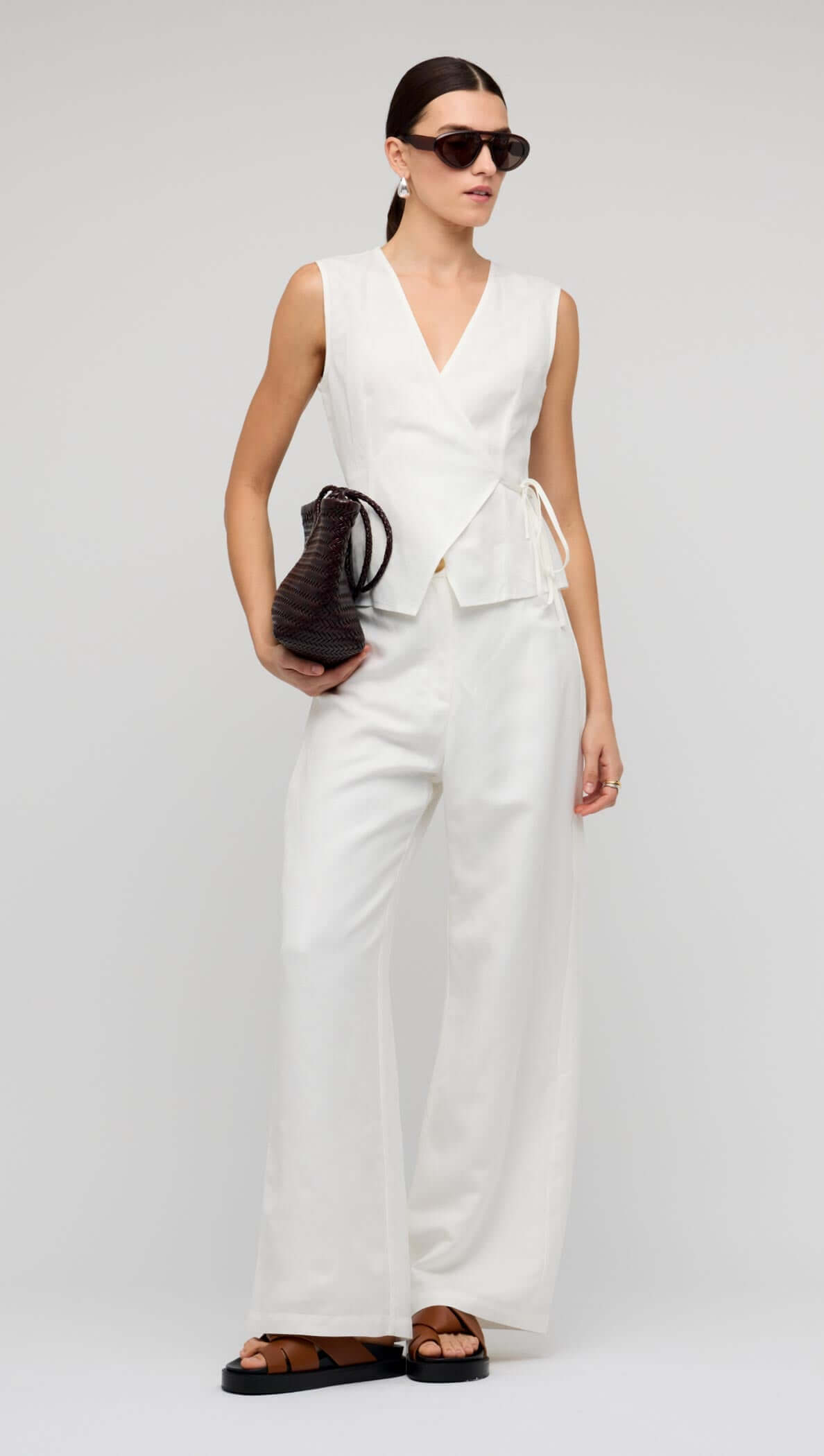 Model wearing White Linen Wide Leg Pants with a matching wrap top and sunglasses.