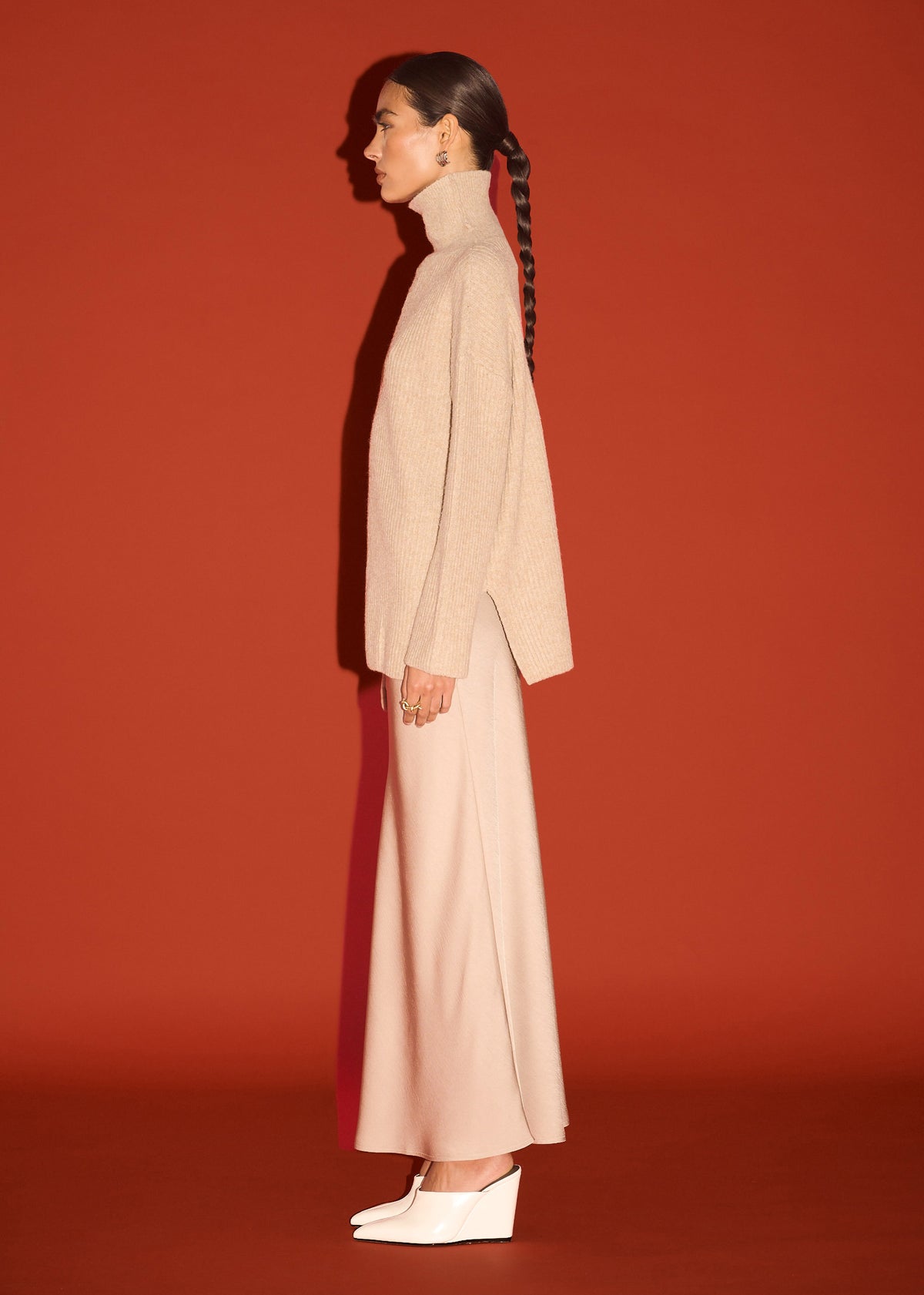 Side view of the Oatmeal Roll Neck Oversized Knit Jumper, showing a roll neck neckline and a relaxed fit.