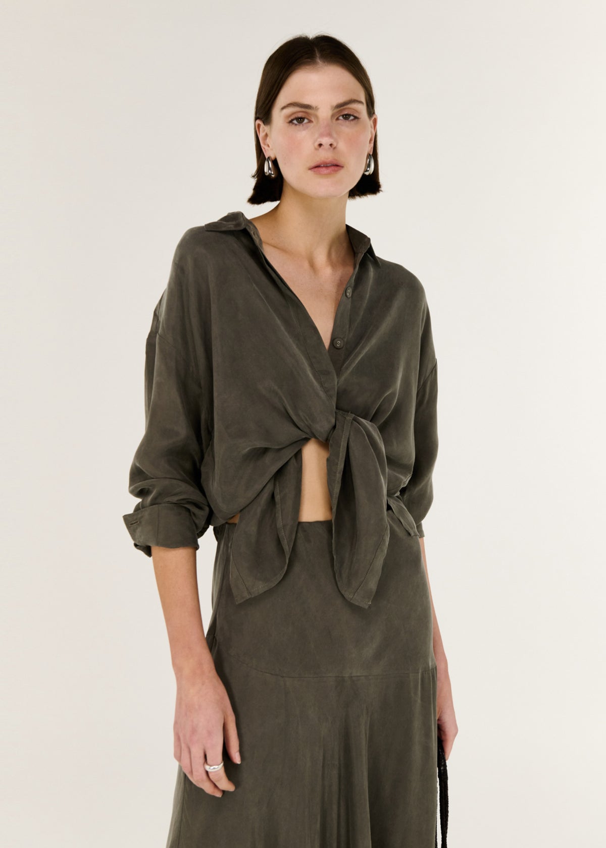 Close-up of the Olive Cupro Oversized Shirt, showing a button through Front.