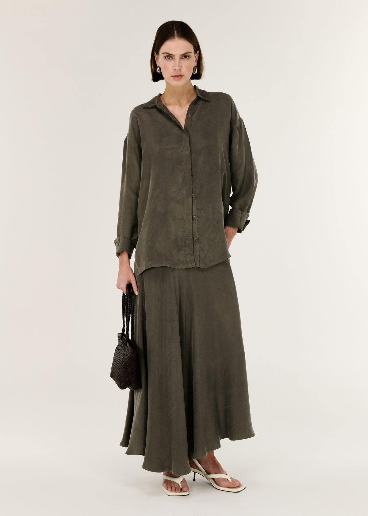Model wearing Olive Cupro Oversized Shirt, showing a colour: Olive and an oversized Fit.