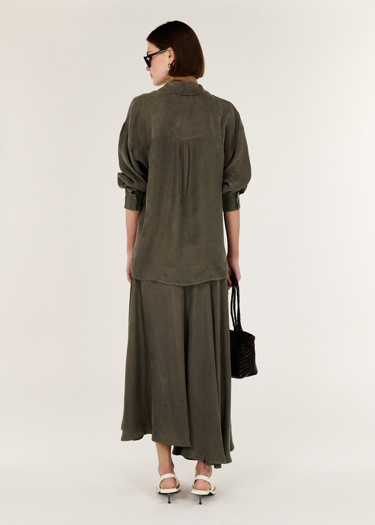 Back view of the Olive Cupro Oversized Shirt with a button through Front and an oversized Fit.