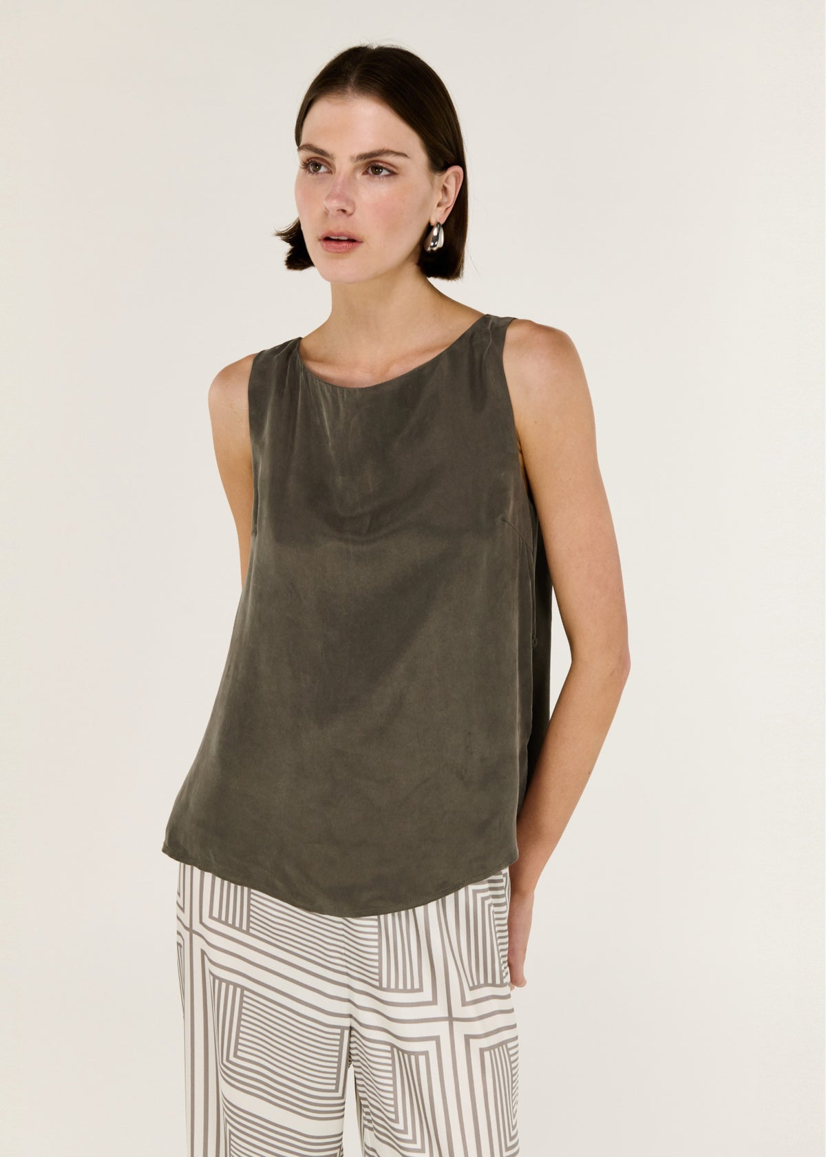 Close-up of the Olive Cupro Waist Tie Tank, showing a sleeveless silhouette and a round neckline.