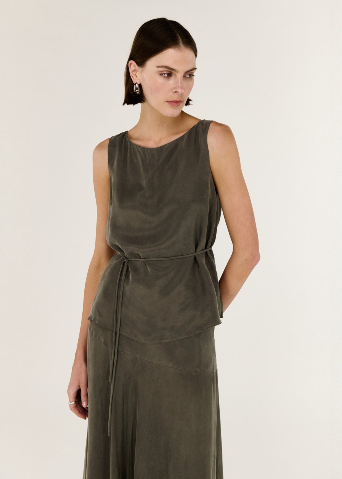 Close-up of the Olive Cupro Waist Tie Tank, showing a round neckline and a sleeveless silhouette.