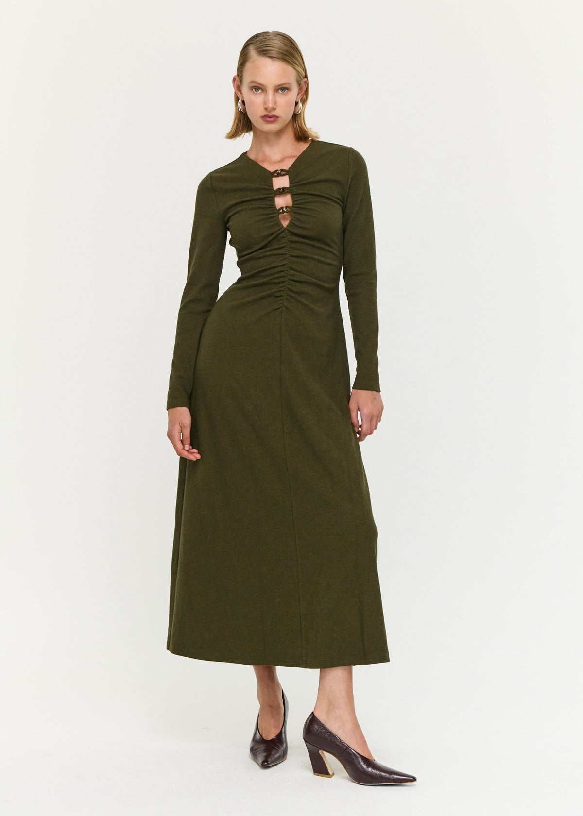 Model wearing Olive Green Bead Detail Jersey Midi Dress with long sleeves and a midi length.