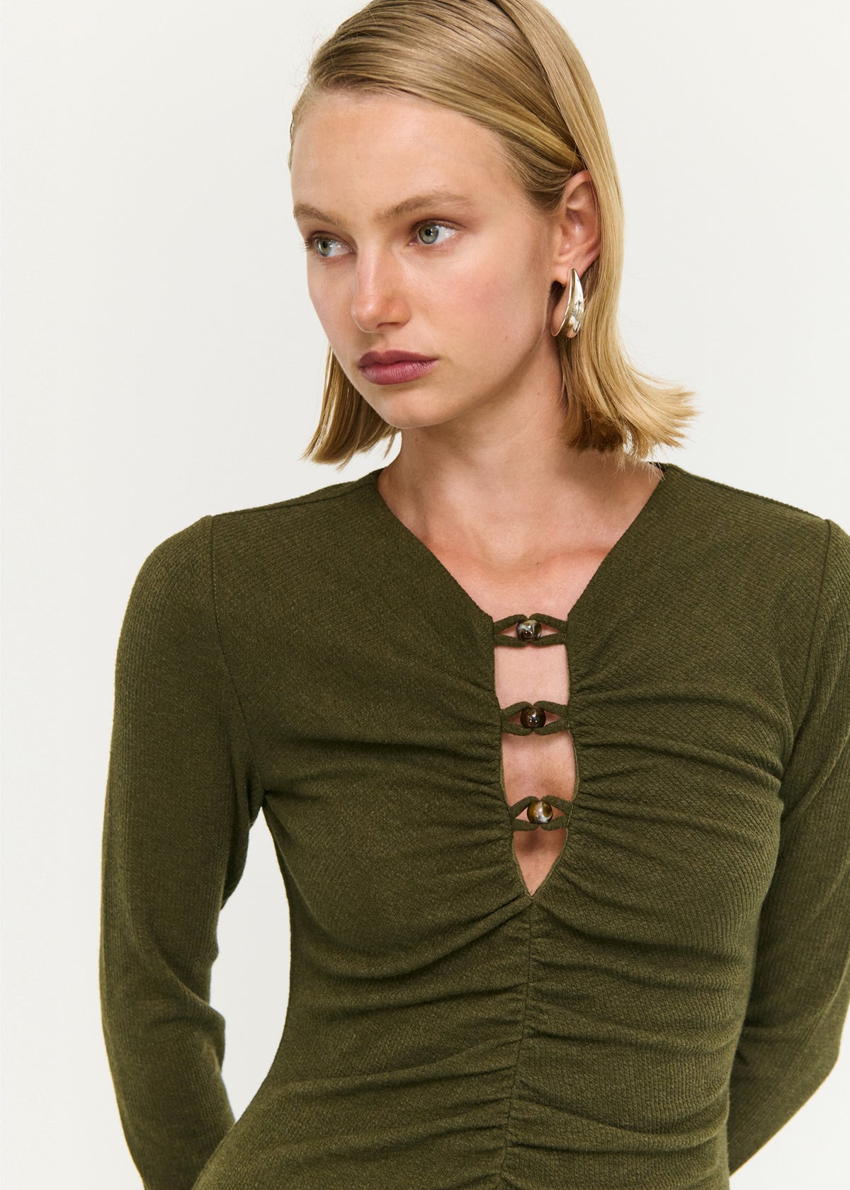 Close-up detail of the Olive Green Bead Detail Jersey Midi Dress, showing beaded ruched neckline.