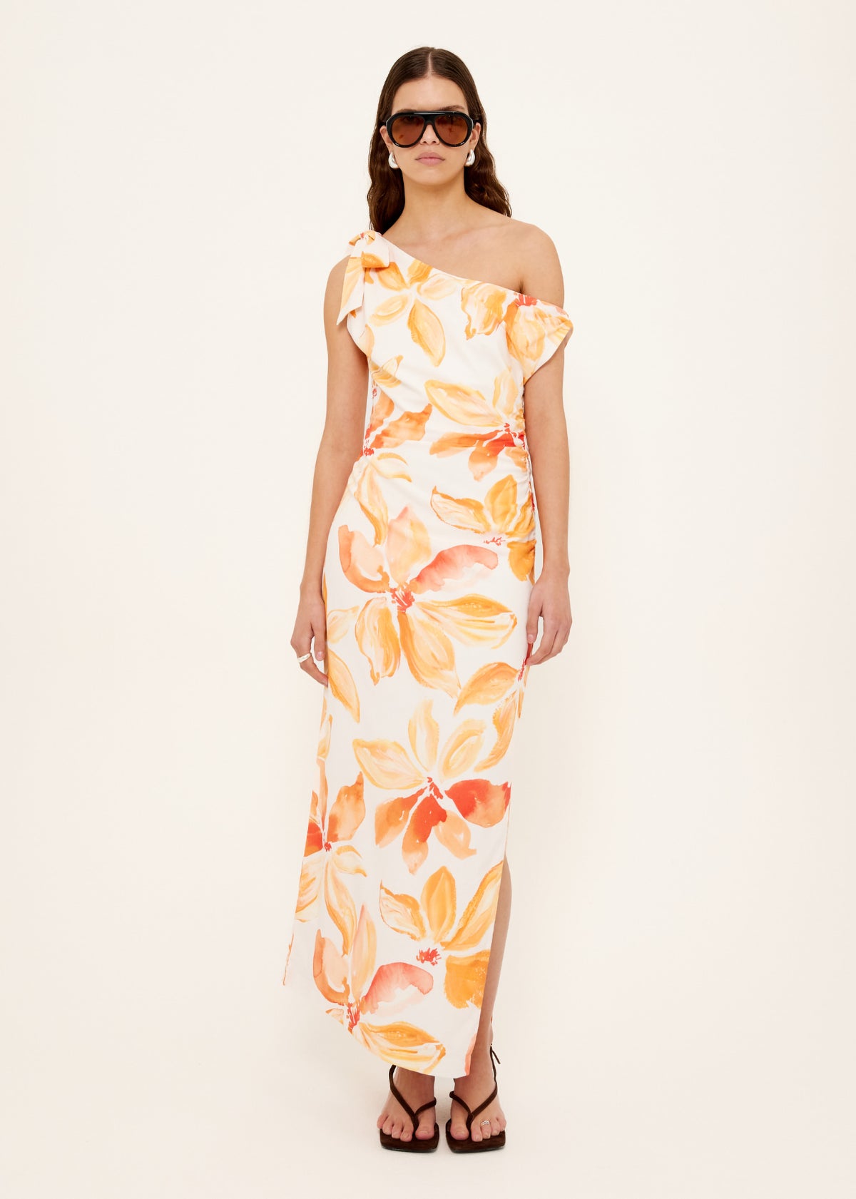 Model wearing Orange and White Floral Asymmetric Midi Dress with an exclusive Staple floral print.