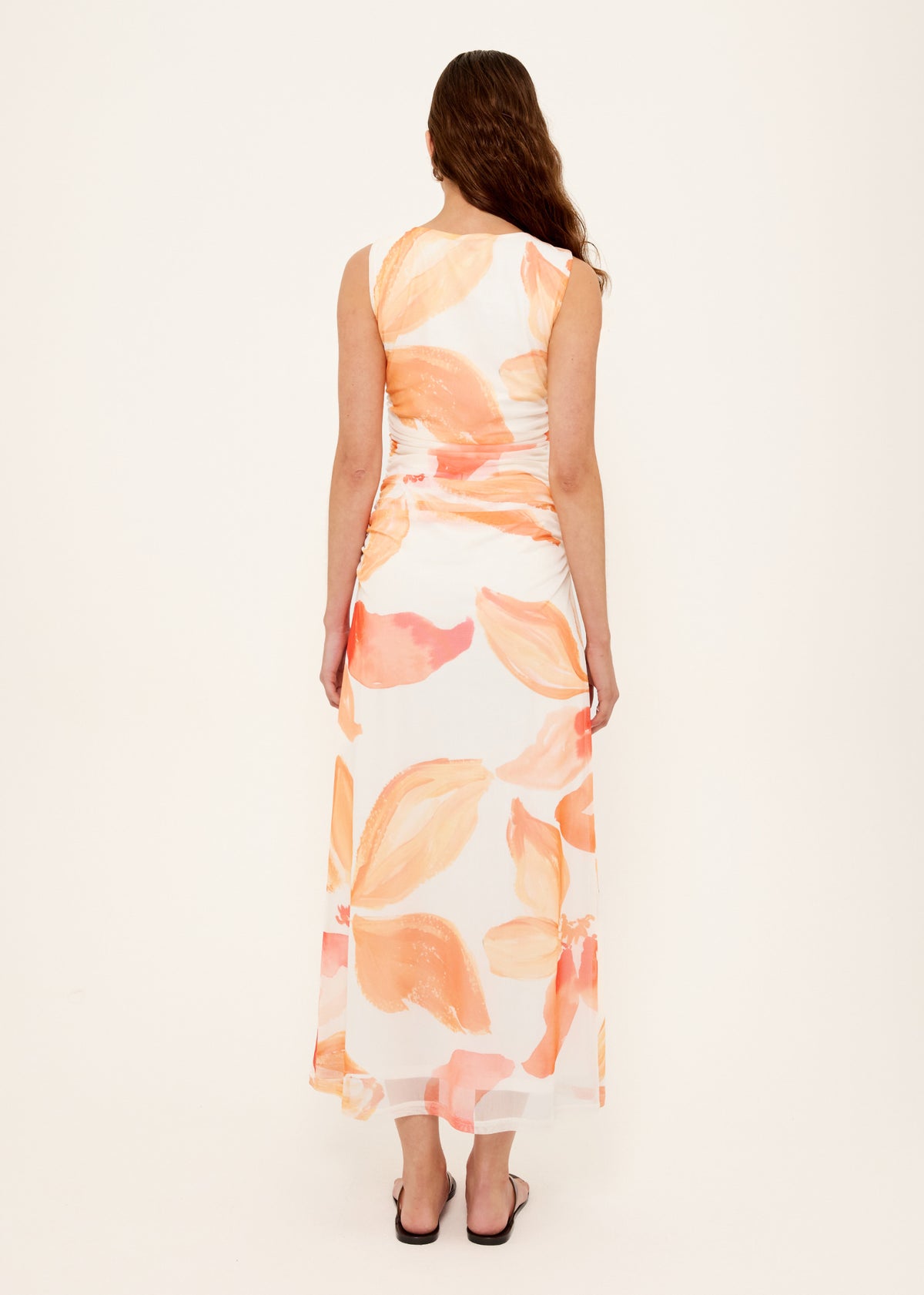 Back view of the Orange and White Floral Mesh Midi Dress with a soft mesh fabrication and abstract floral print in warm peach tones.