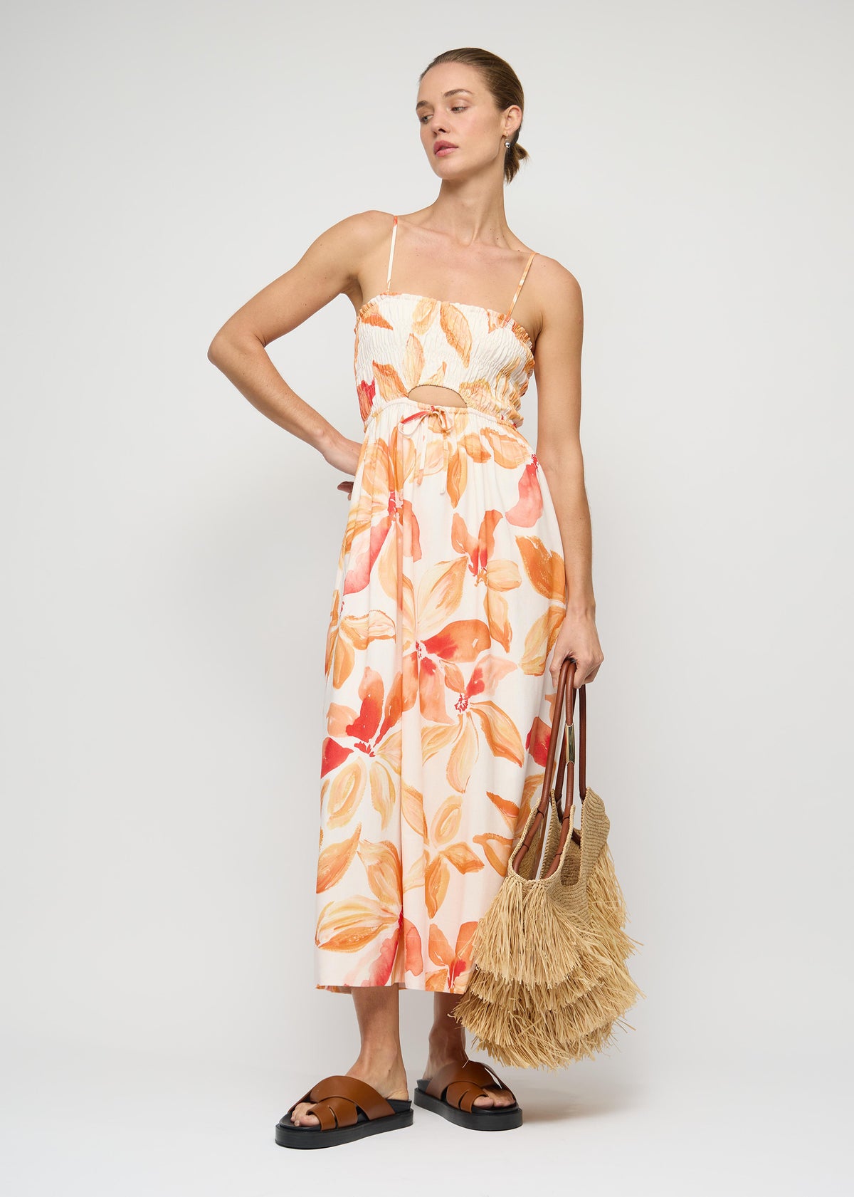 Model wearing Orange and White Floral Shirred Midi Dress with an exclusive Staple floral print and shirred bodice with adjustable straps.