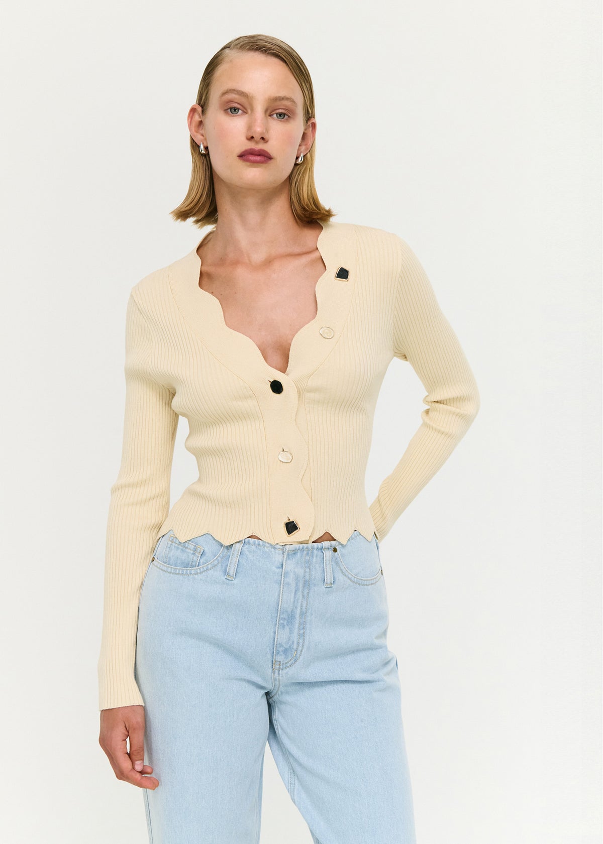 Close-up of the Ornate Button Scallop Neck Cardigan in Yellow, showing a scalloped neckline and hem.