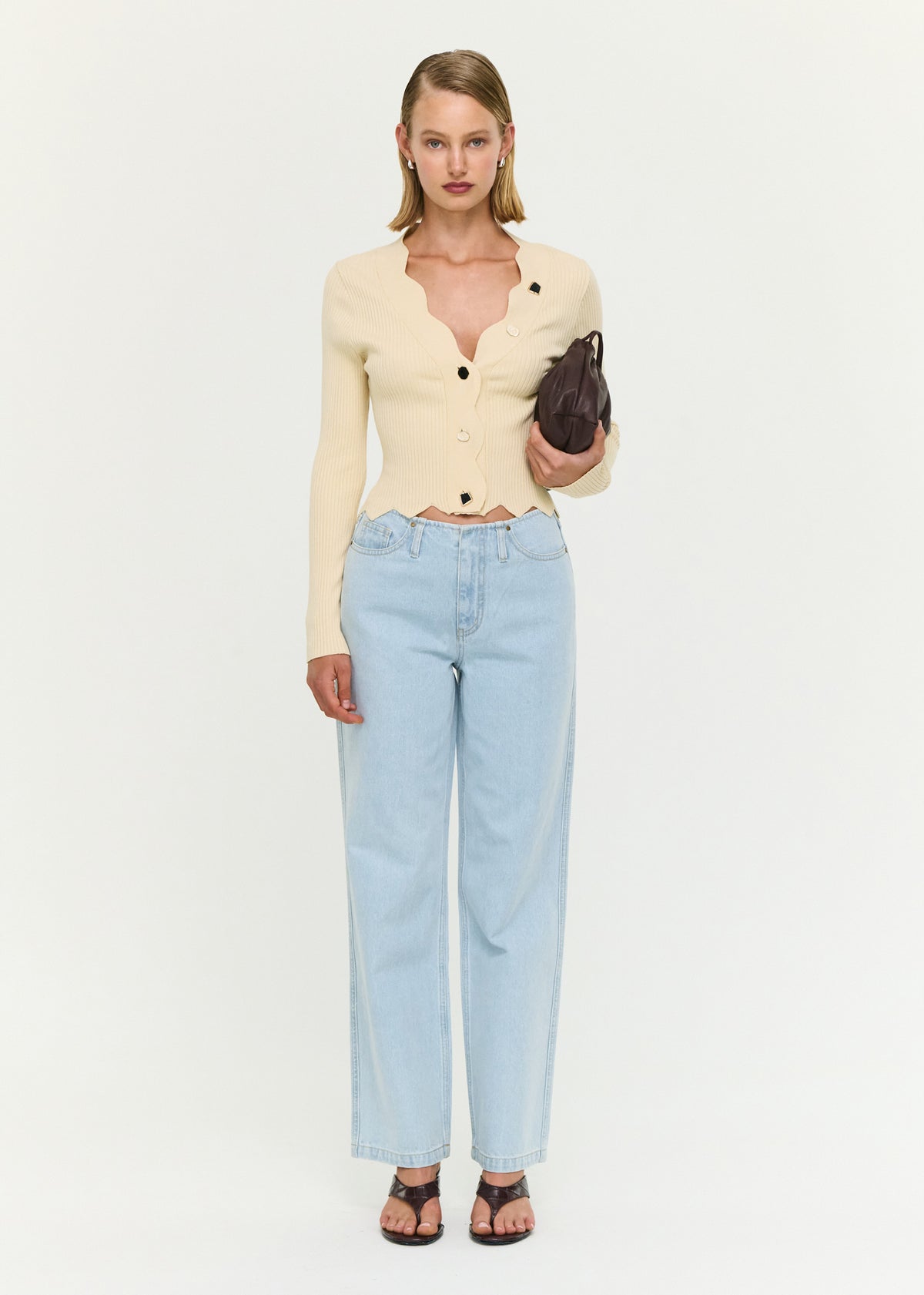 Model wearing Ornate Button Scallop Neck Cardigan in Yellow with a scalloped neckline and hem.