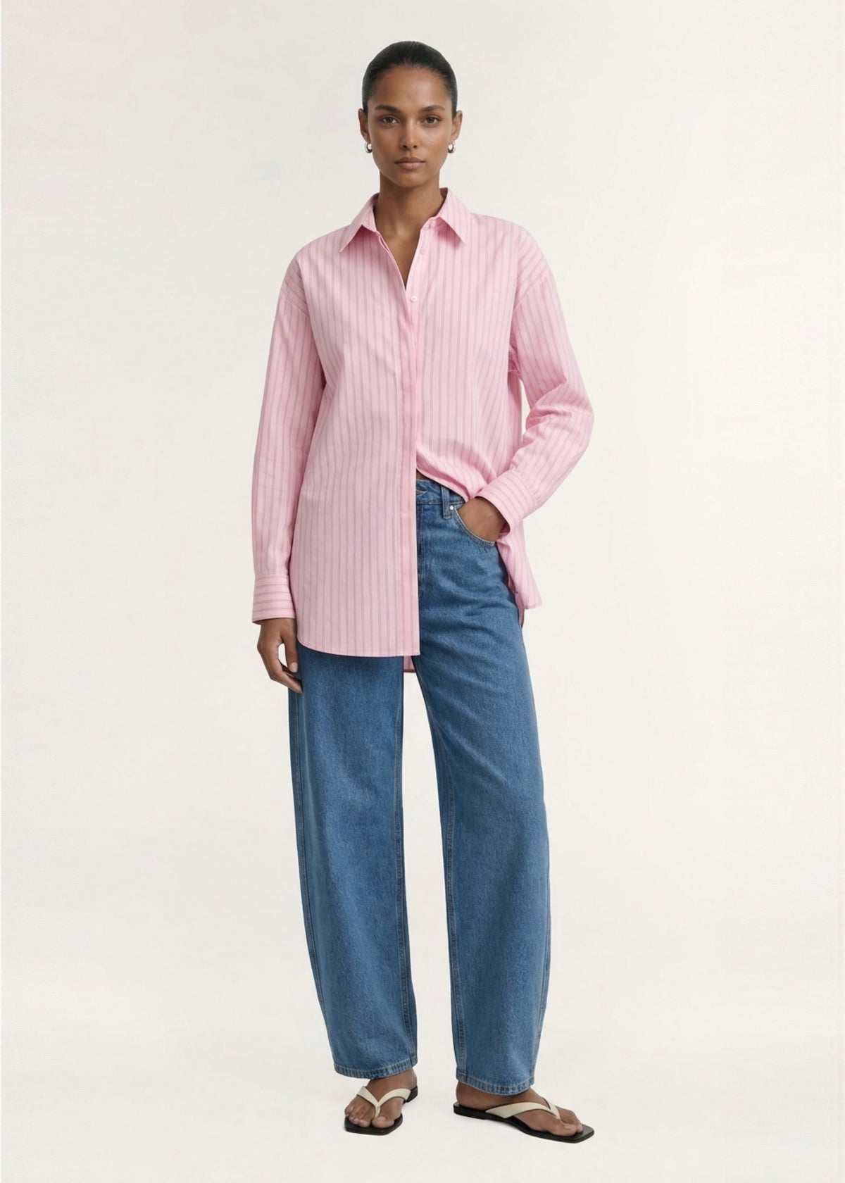 Model wearing Oversized Cotton Shirt with Back Button Detail with a back tab detail and a relaxed, effortless fit.
