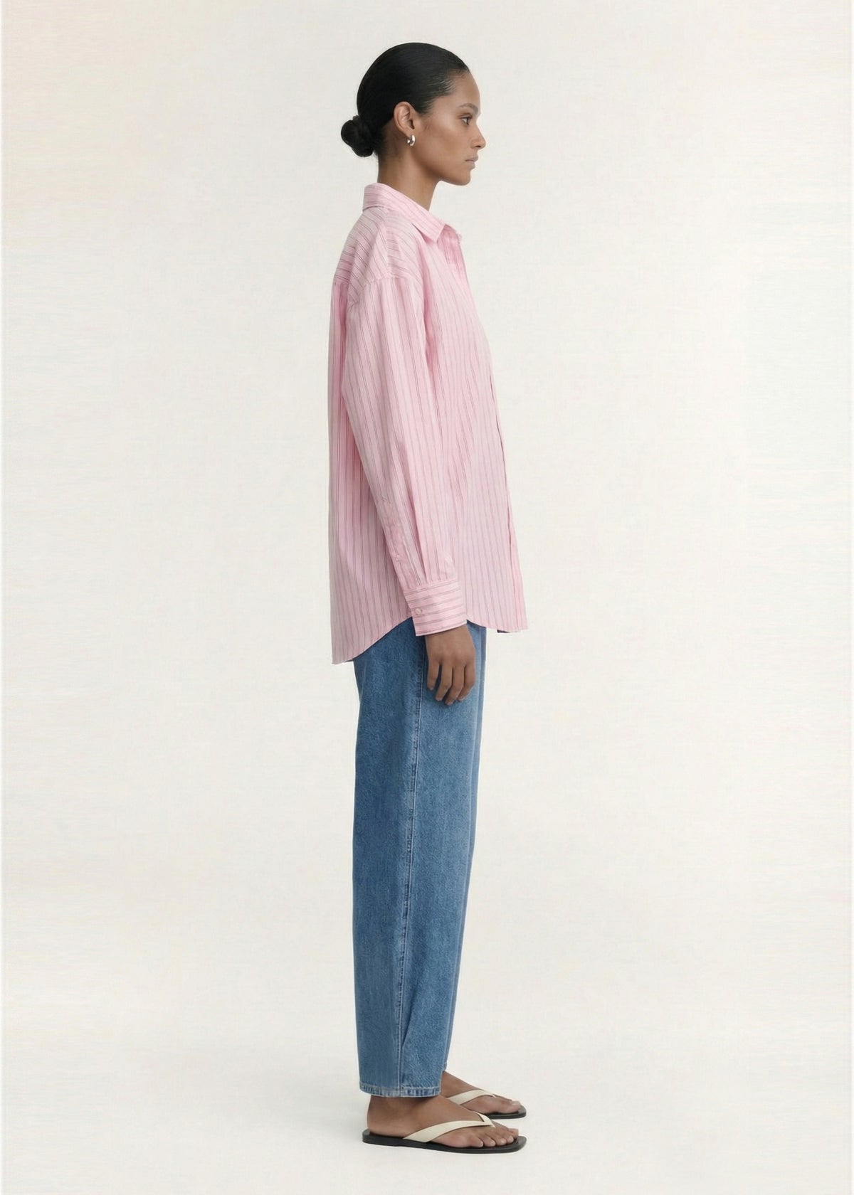 Side view of the Oversized Cotton Shirt with Back Button Detail, showing an oversized silhouette and a classic collar neckline.