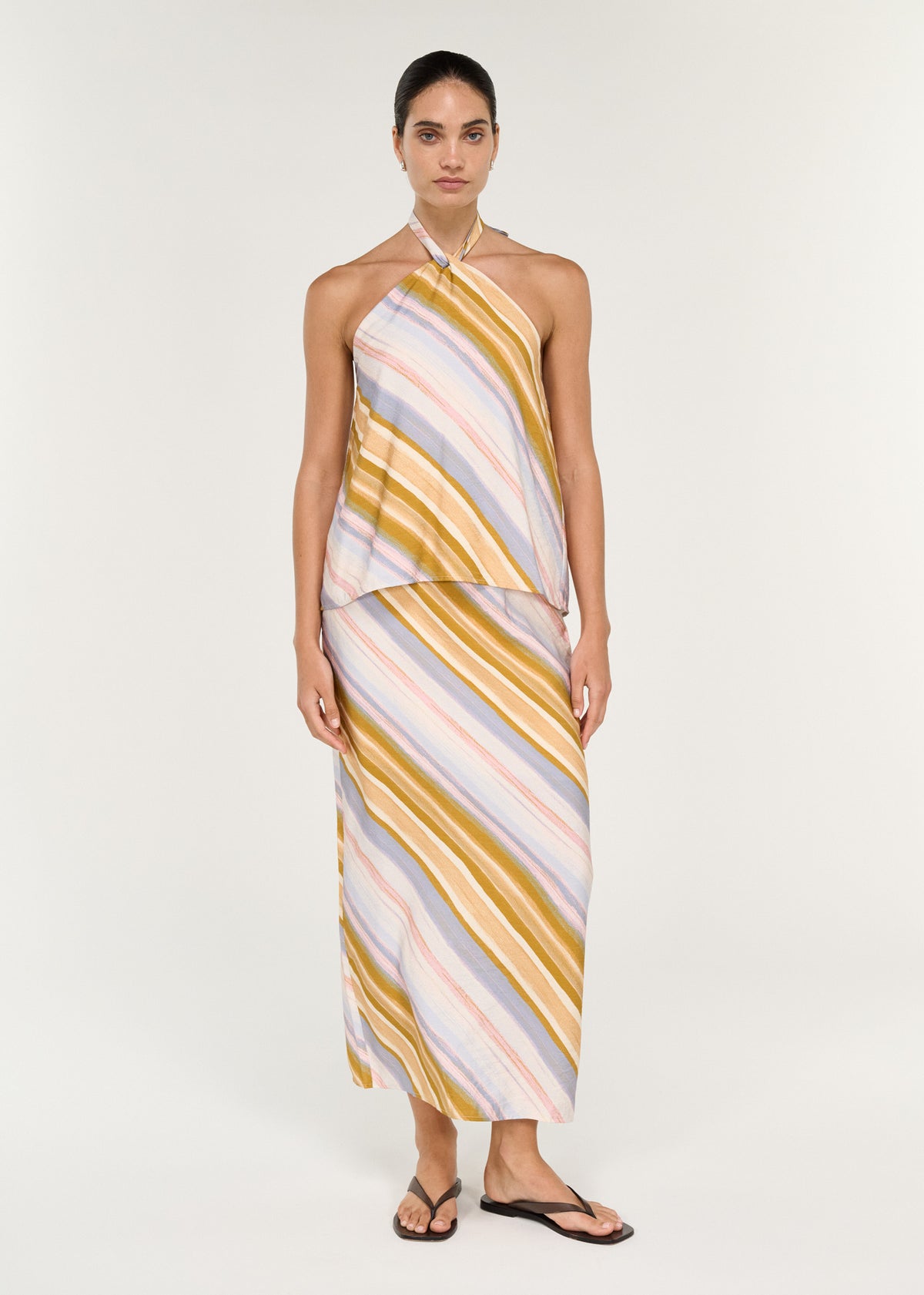 Model wearing Pastel Stripe Mid Rise Midi Skirt with a painterly diagonal stripe print and a midi length.