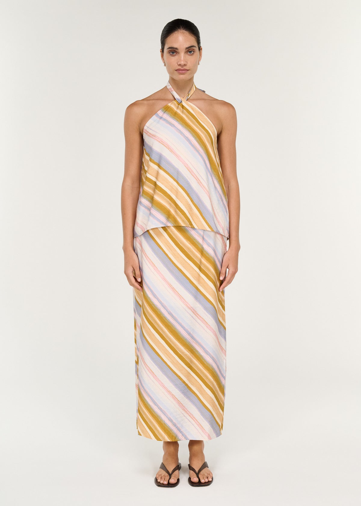 Model wearing Pastel Stripe Mid Rise Midi Skirt, showing a straight, fluid silhouette and a clean waistband.