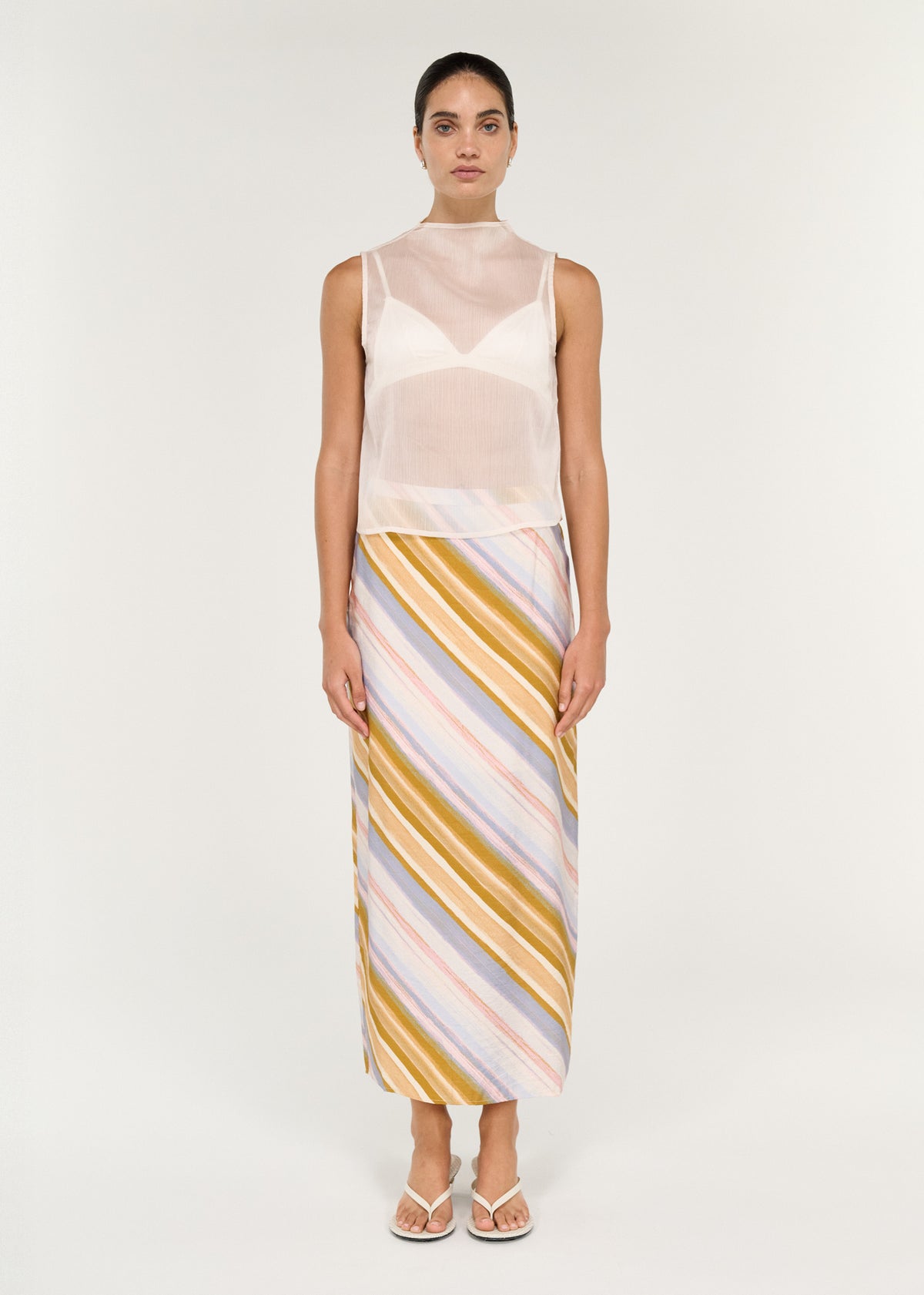 Model wearing Pastel Stripe Mid Rise Midi Skirt with a clean waistband and a back split.