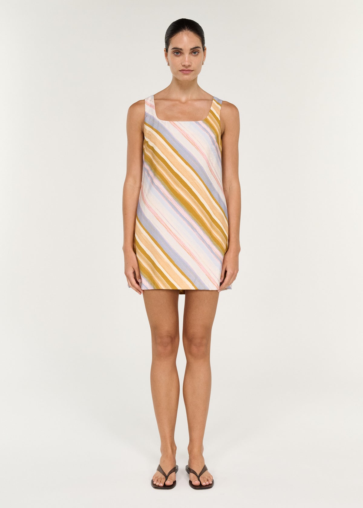 Model wearing Pastel Stripe Square Neck Mini Dress with a painterly diagonal stripe print and a mini length.
