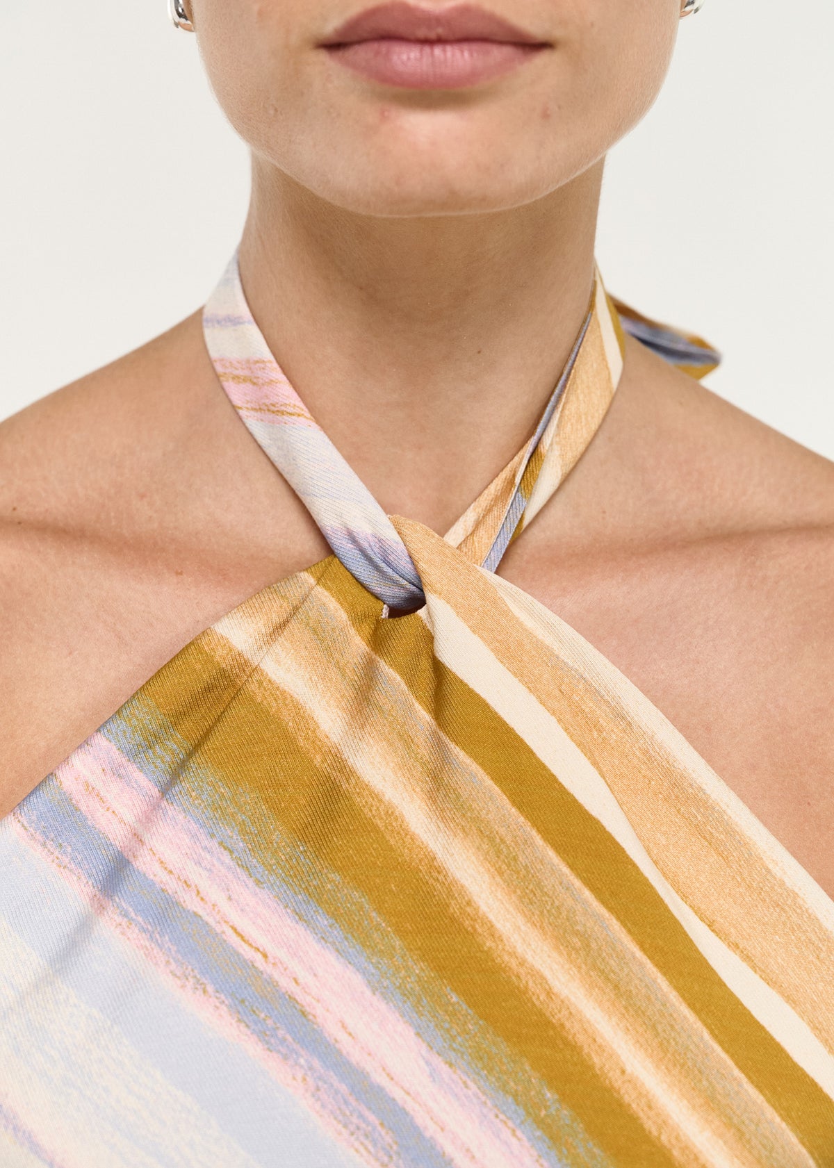 Close-up detail of the Pastel Stripe Twist Detail Halter Top, showing twisted halter neckline.