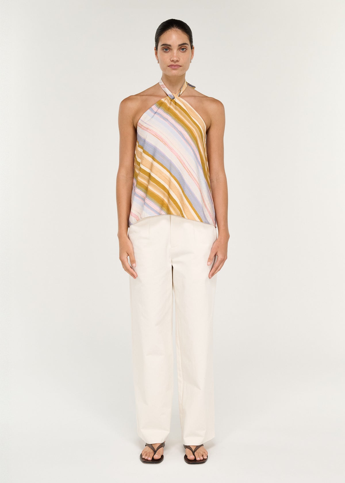 Model wearing Pastel Stripe Twist Detail Halter Top with a sleeveless silhouette and an open back.