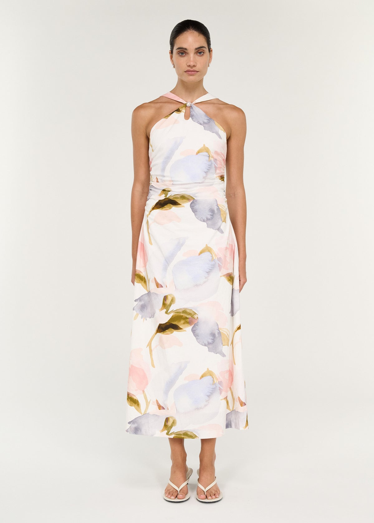 Model wearing Pastel Watercolour Cotton Midi Dress with Halter Neck with a lightweight woven fabrication.