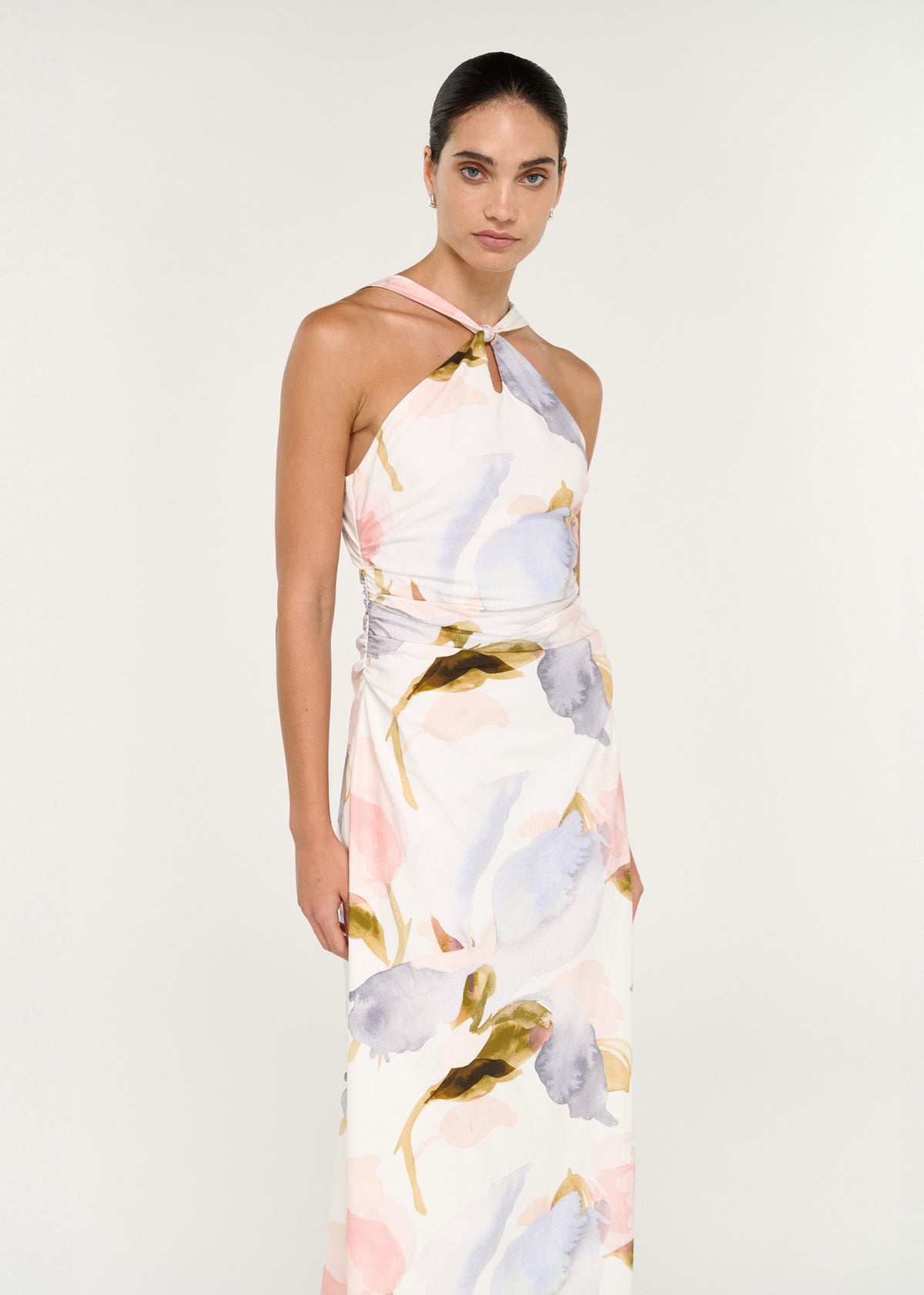 Model wearing Pastel Watercolour Cotton Midi Dress with Halter Neck, showing a halter neckline and cross-over neck straps.
