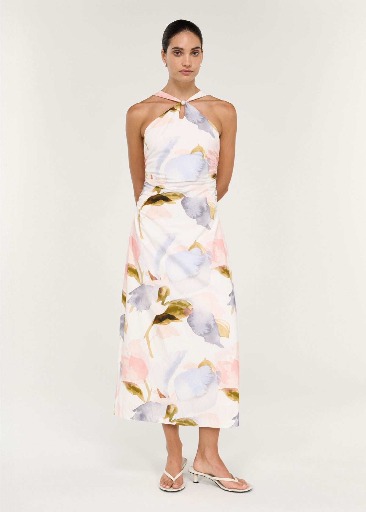 Model wearing Pastel Watercolour Cotton Midi Dress with Halter Neck with a front keyhole with bead detail and a sleeveless cut.