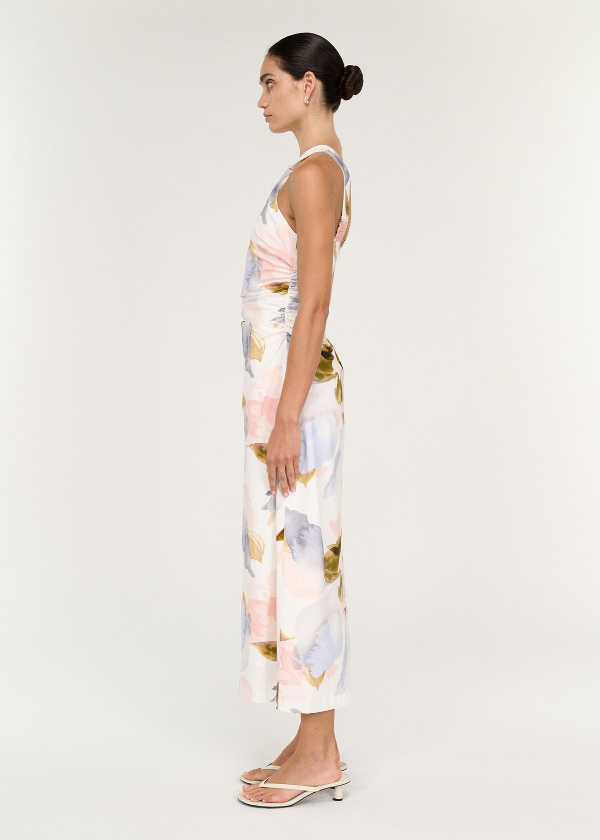 Side view of the Pastel Watercolour Cotton Midi Dress with Halter Neck, showing a gathered side detailing and a softly draped waist.