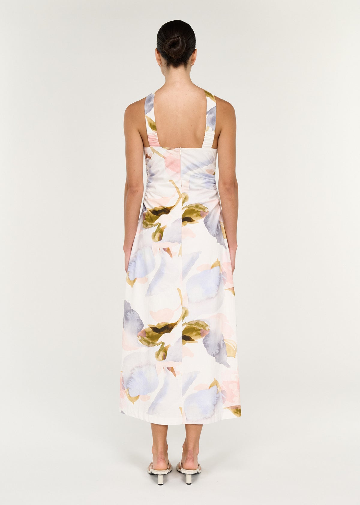 Back view of the Pastel Watercolour Cotton Midi Dress with Halter Neck with cross-over neck straps and an open back.
