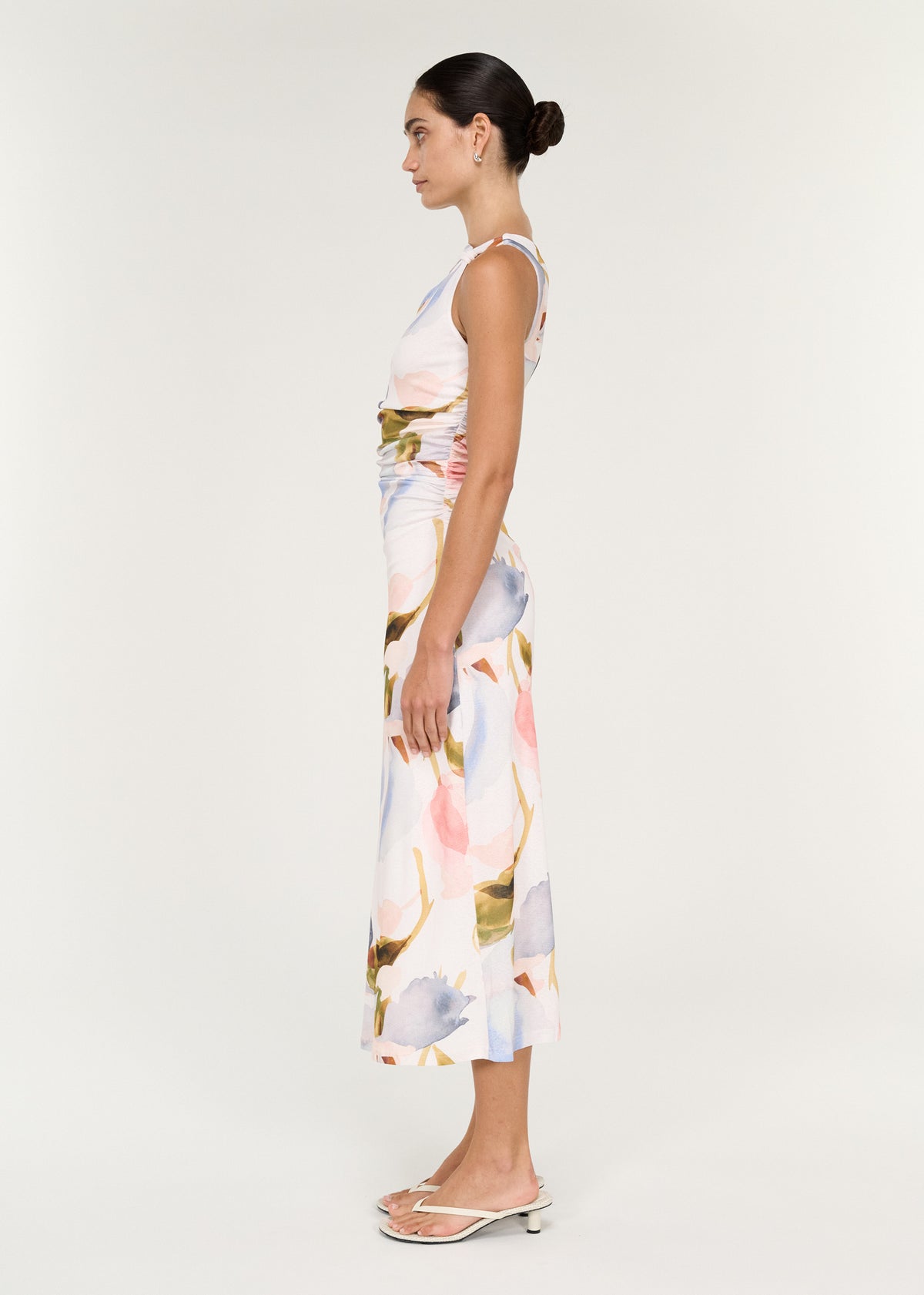 Side view of the Pastel Watercolour Sleeveless Mesh Midi Dress, showing a sleeveless silhouette and a ruched waist detailing.