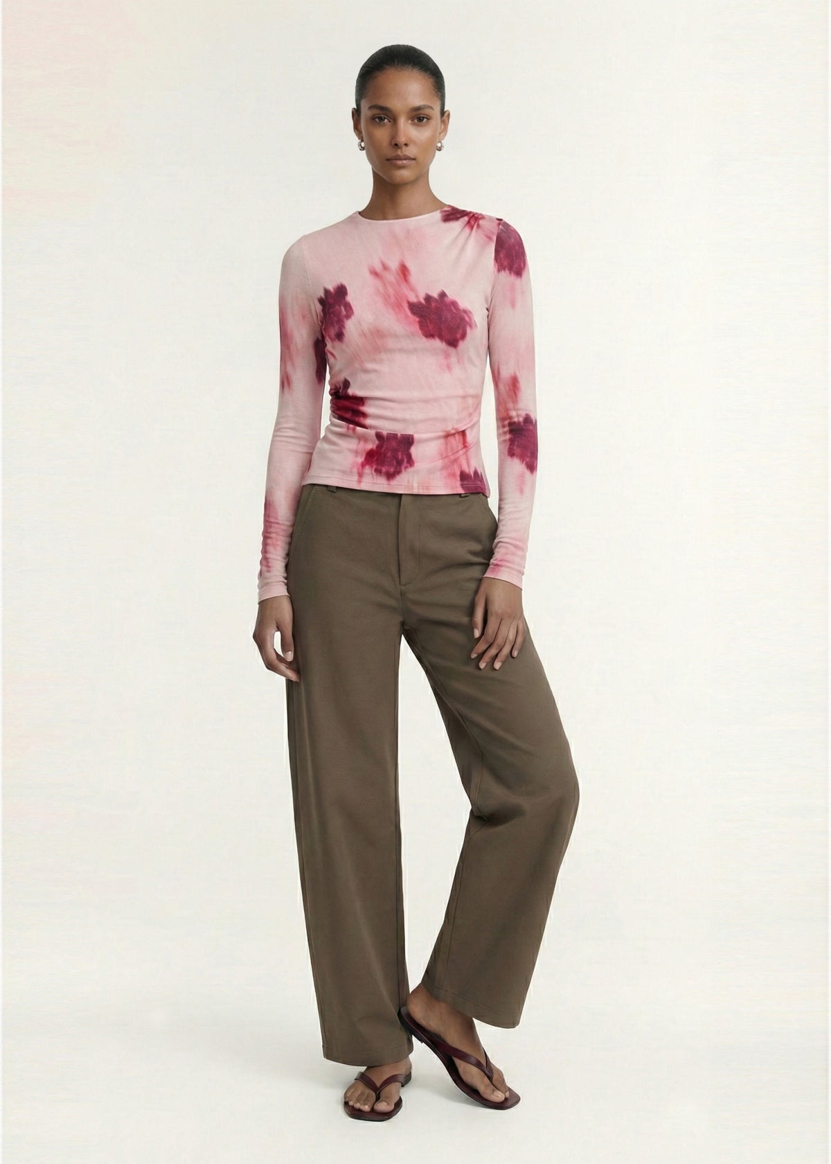 Model wearing Pink Floral Mesh Long Sleeve Top with a printed stretch mesh fabrication and an abstract floral print design.