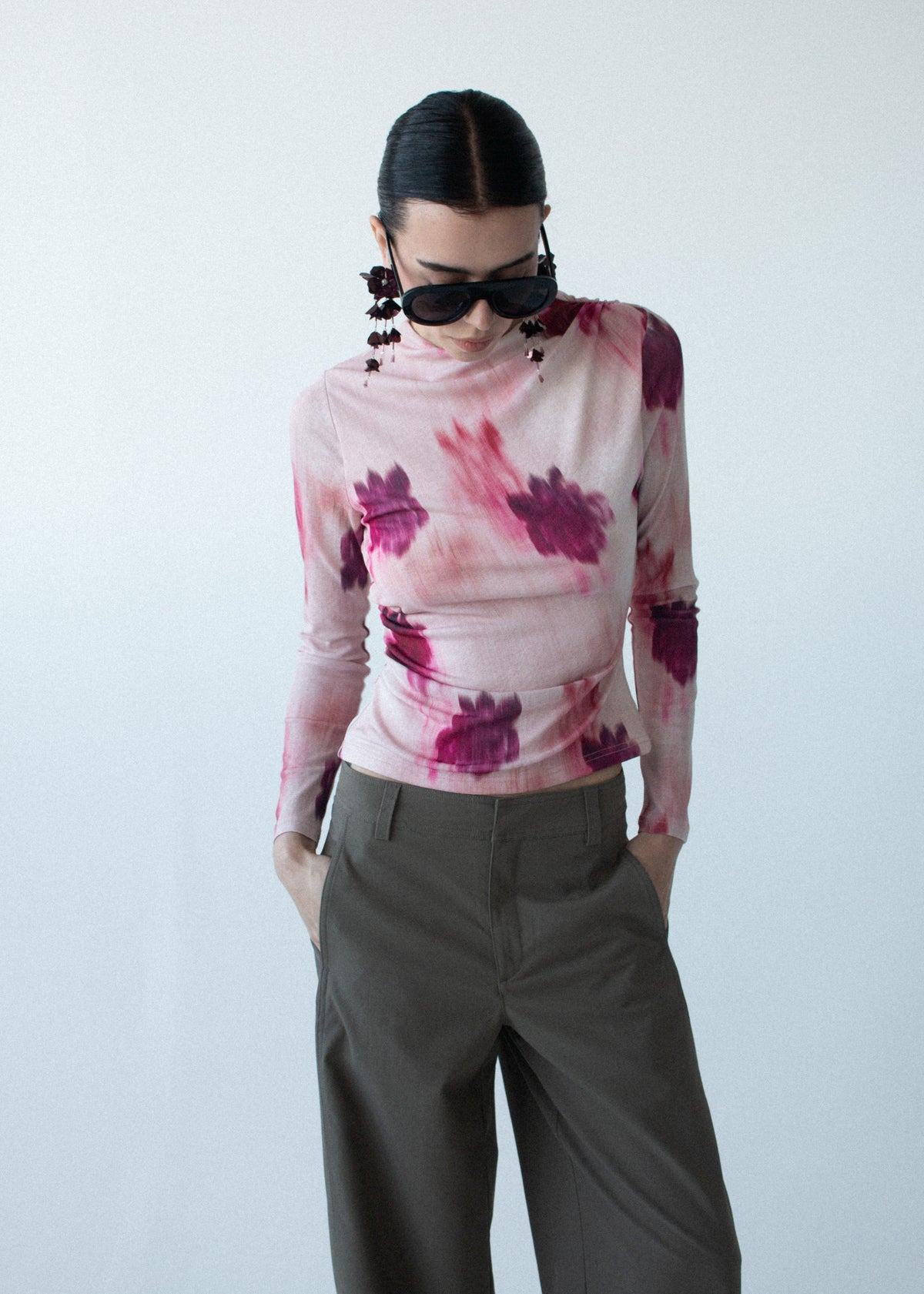 Close-up of the Pink Floral Mesh Long Sleeve Top, showing a high neckline and long sleeves, photographed against a pale blue studio.